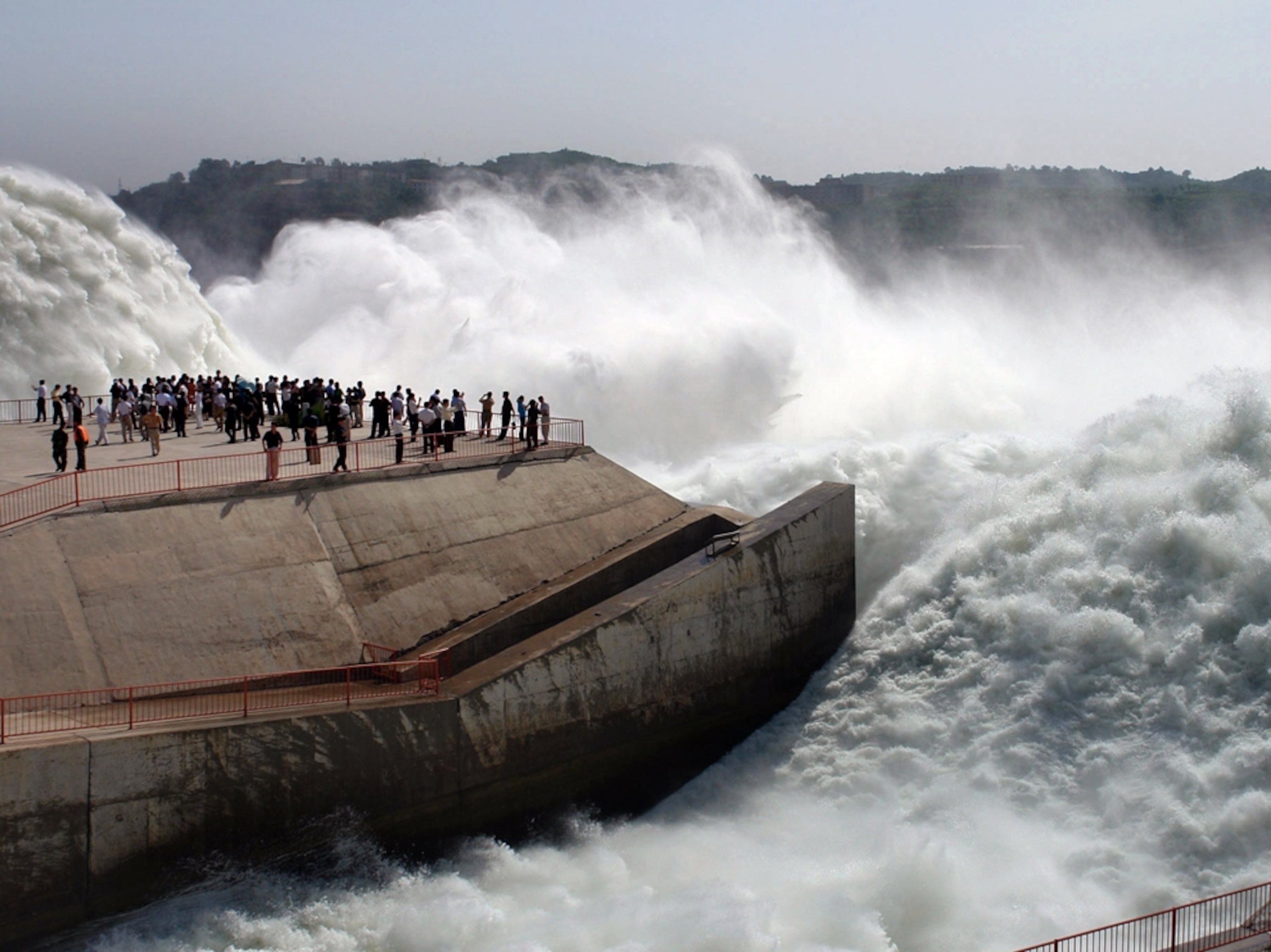 A crowd watches rushing water
