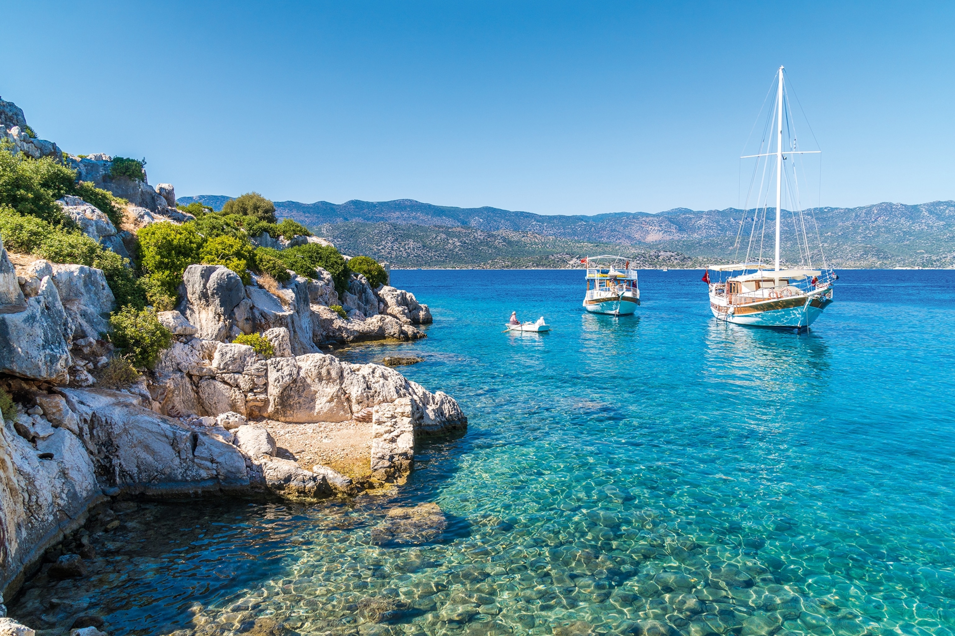 Glistening blue sea waters with boats moored in the water