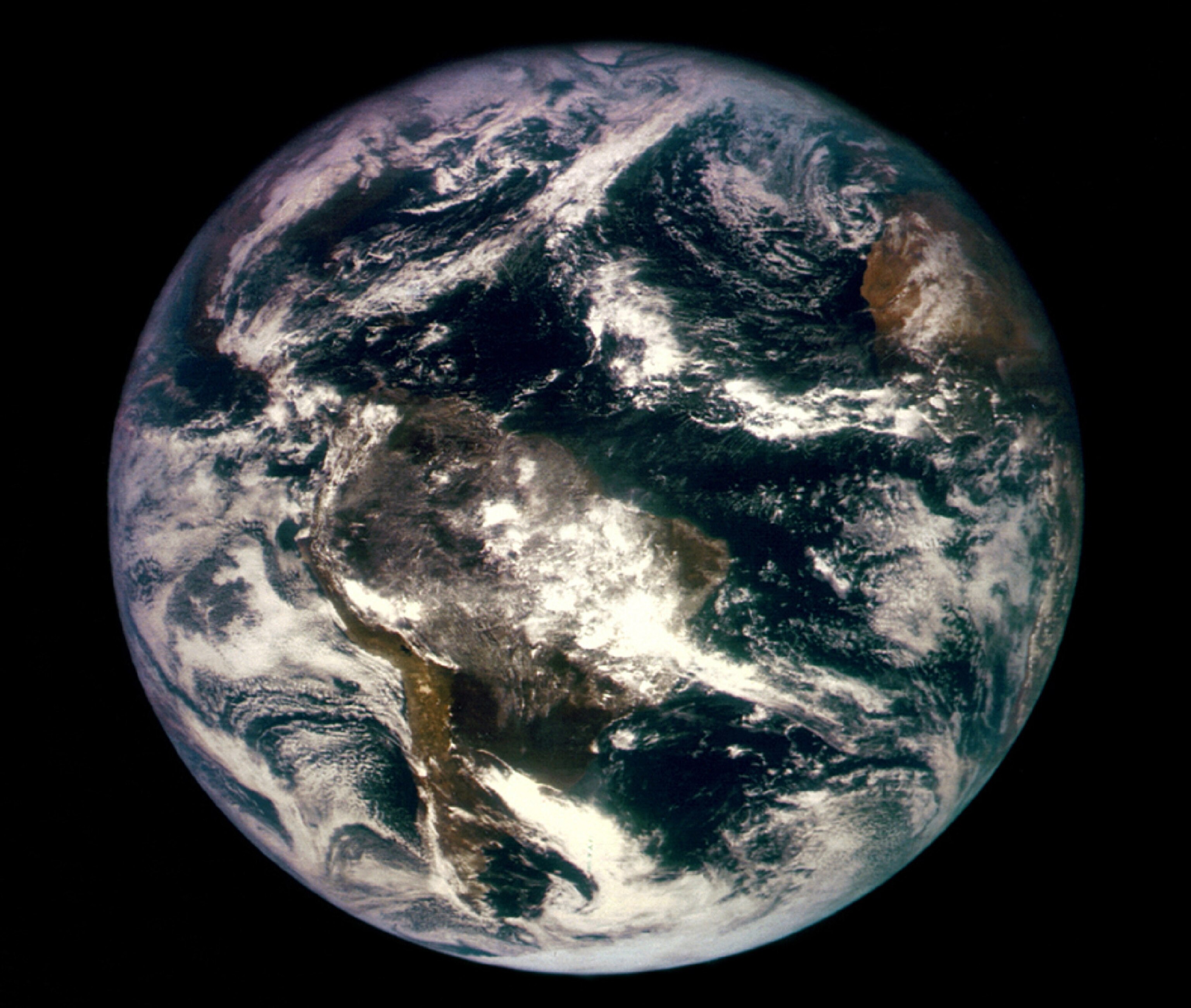 first image of Earth from space like blue disk with white clouds.