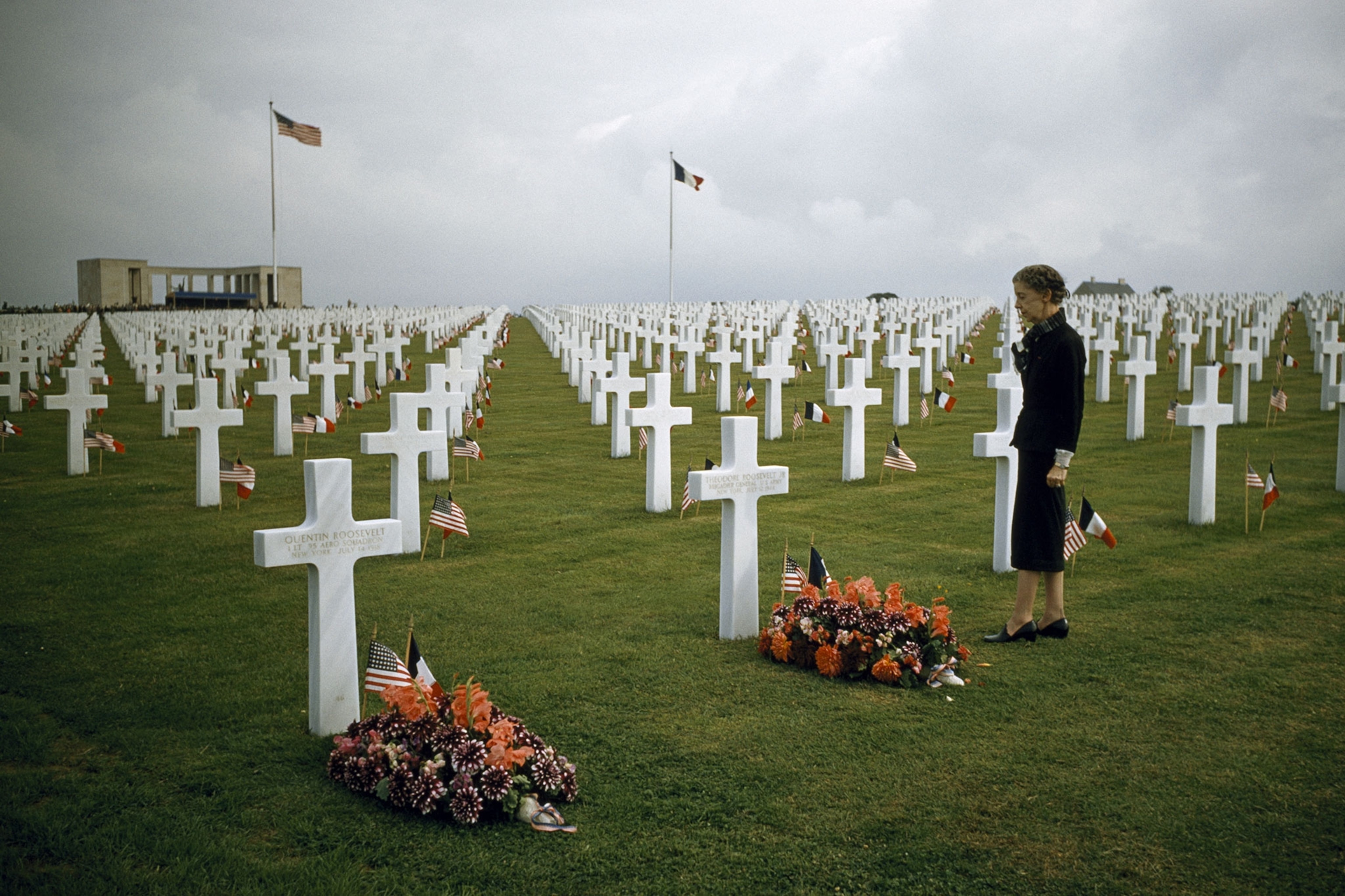 a widow decorating her husband's grave in Normandy
