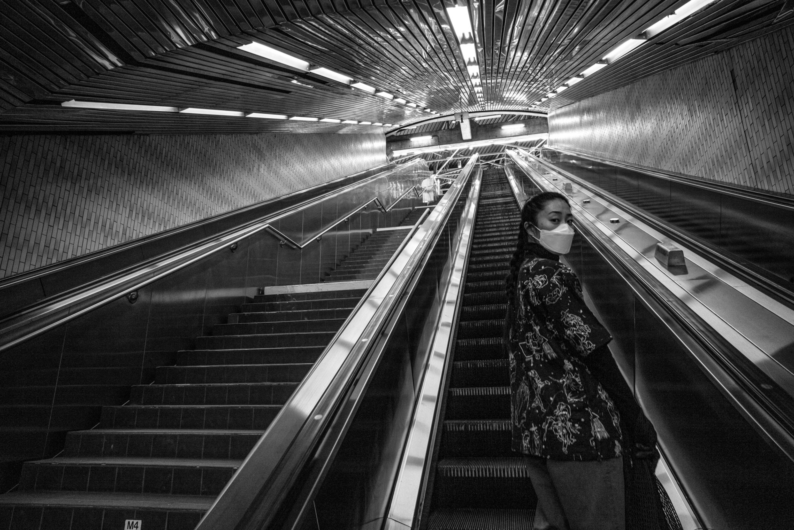 a person riding an escalator up