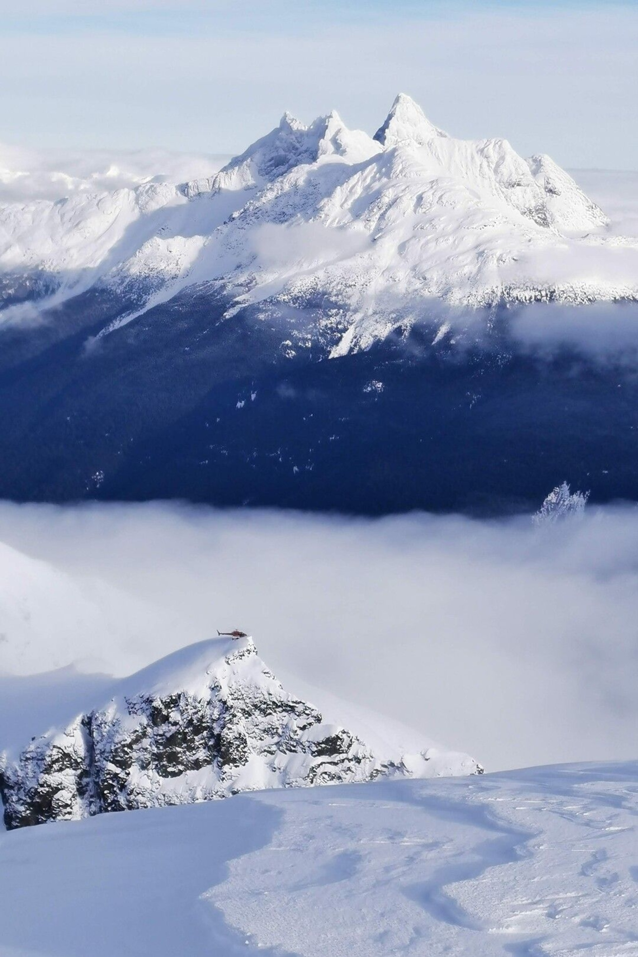 A helicopter waits out clouds above Bella Coola Valley.