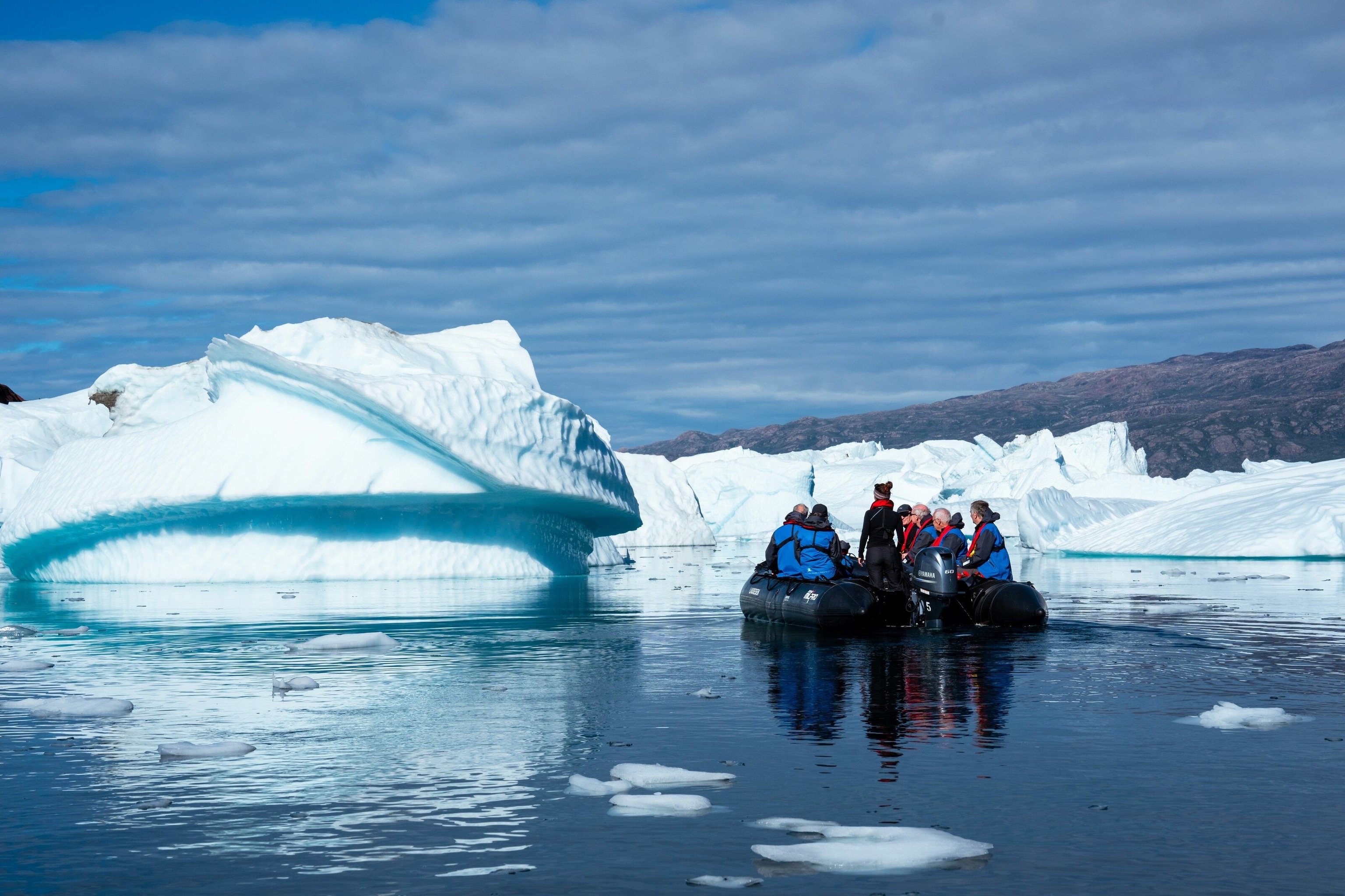 An expedition cruise team out on a Zodiac trip in Greenland.