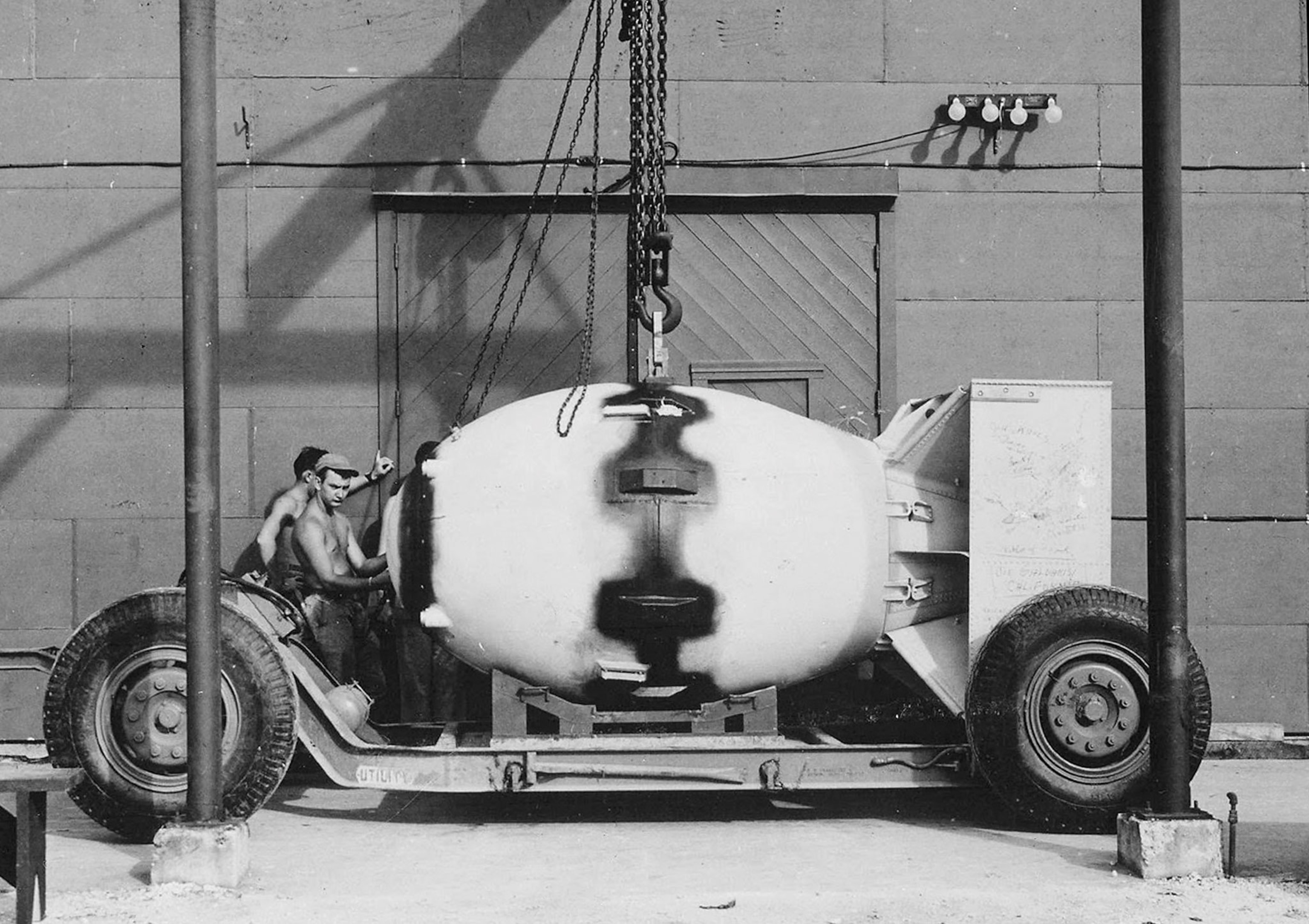 a large bomb being ferried on a cart