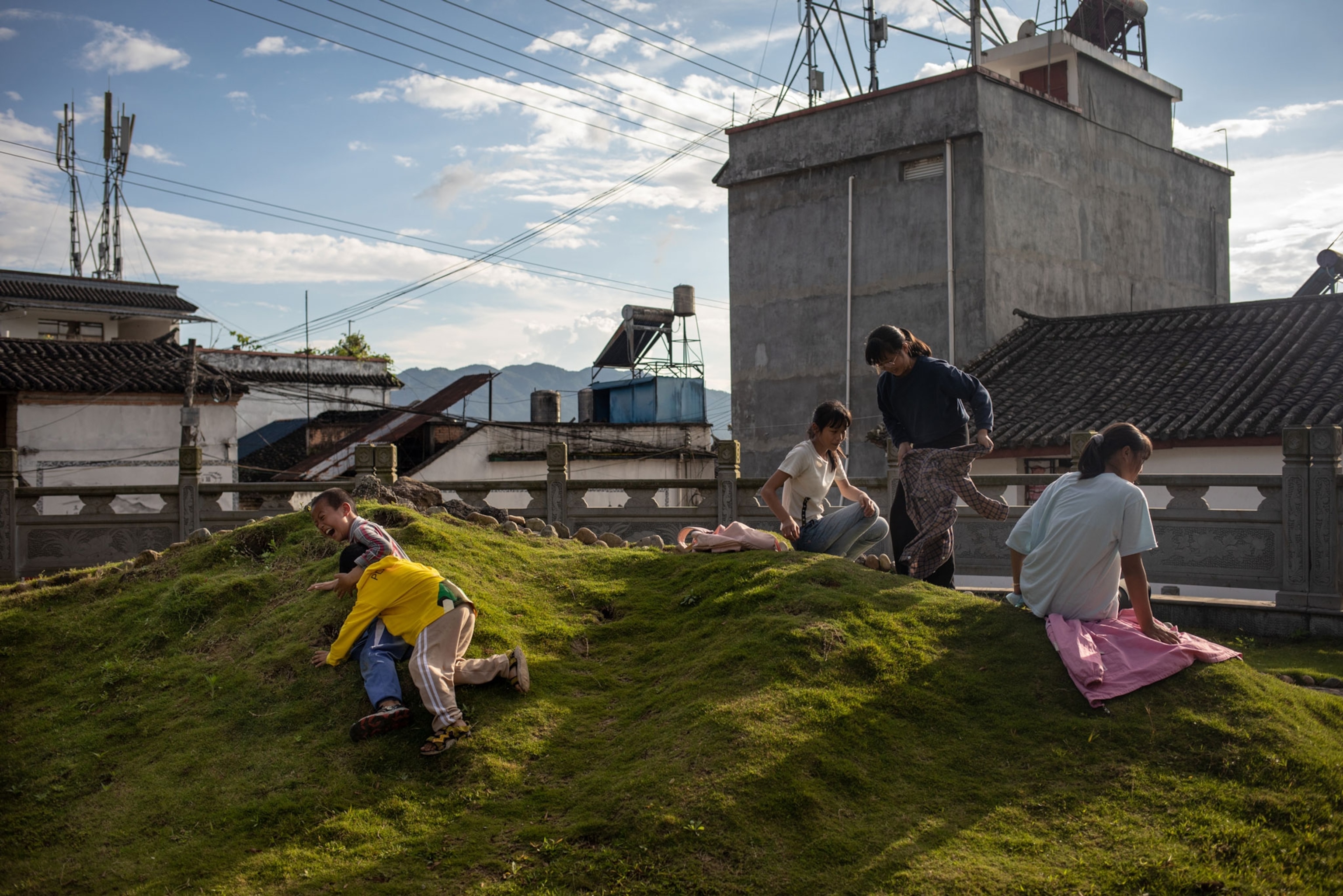photograph of children playing on hill