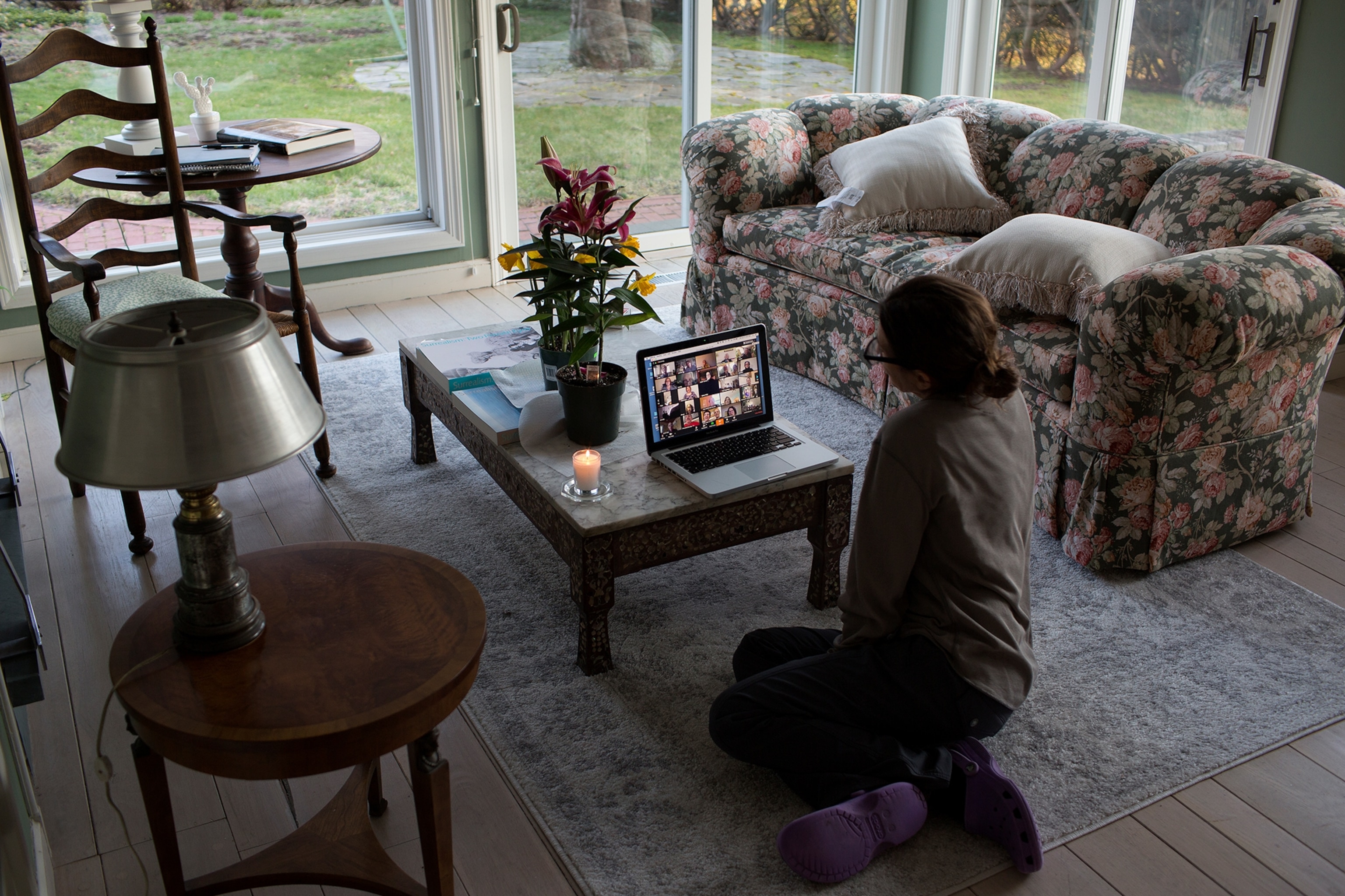 a woman sitting shiva with her family over zoom