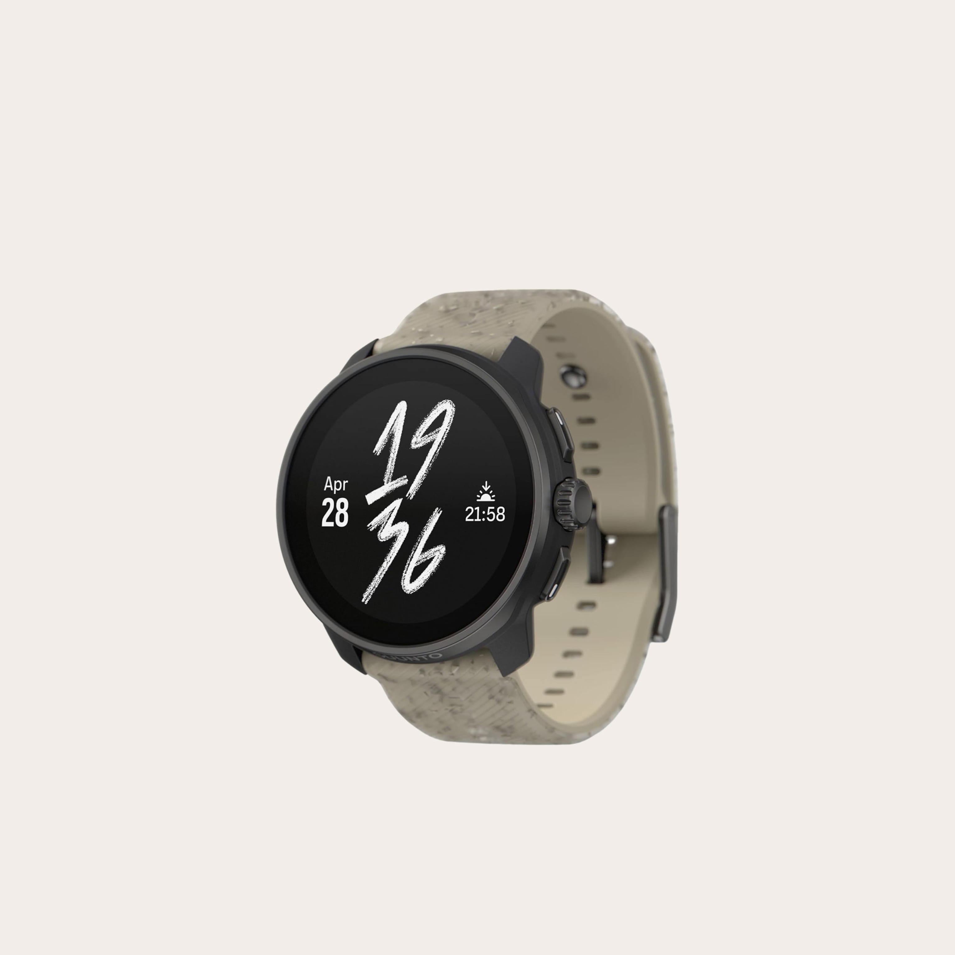 Black and tan watch placed on a tan background.