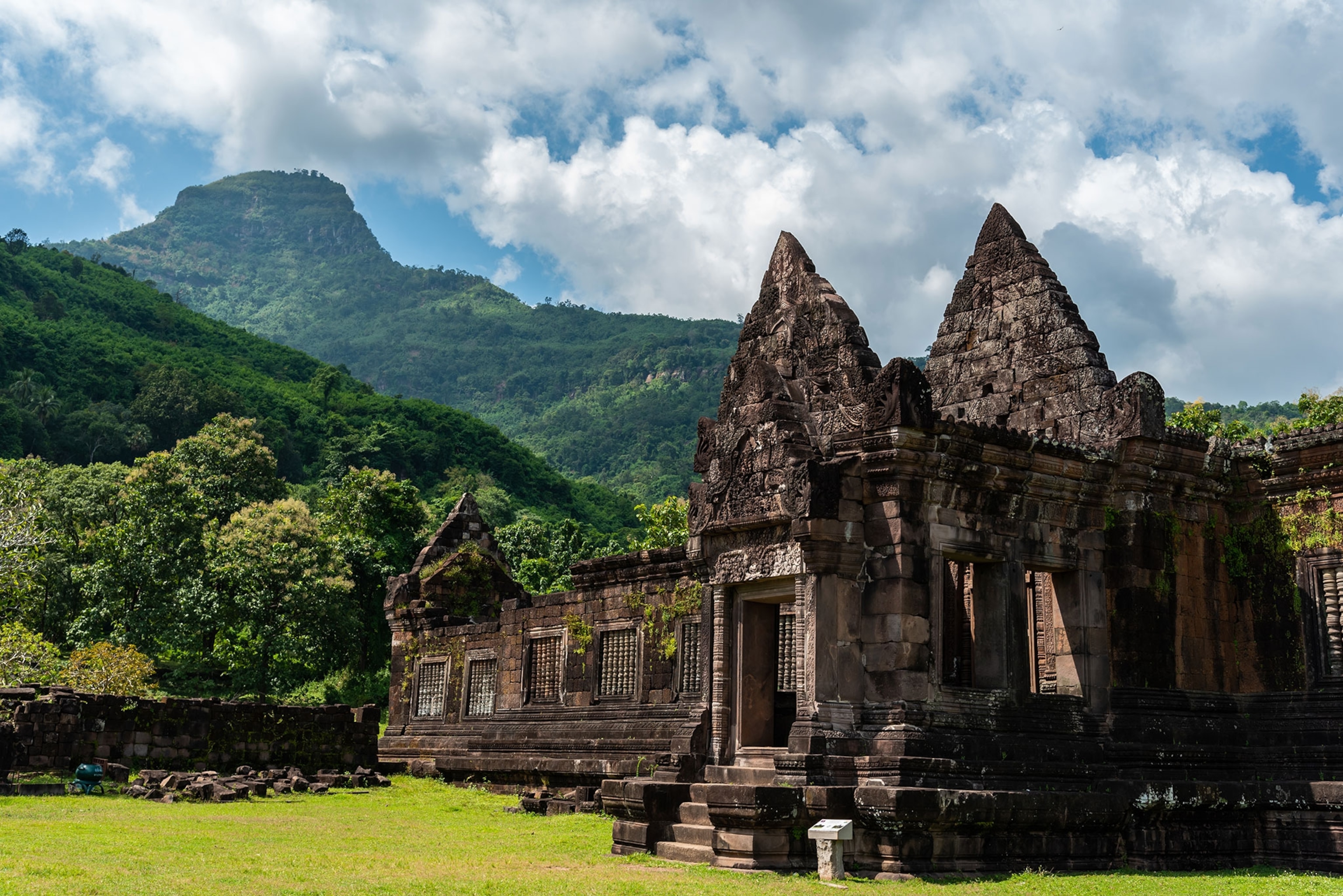 Ancient stone temple with lush green mountains in the background