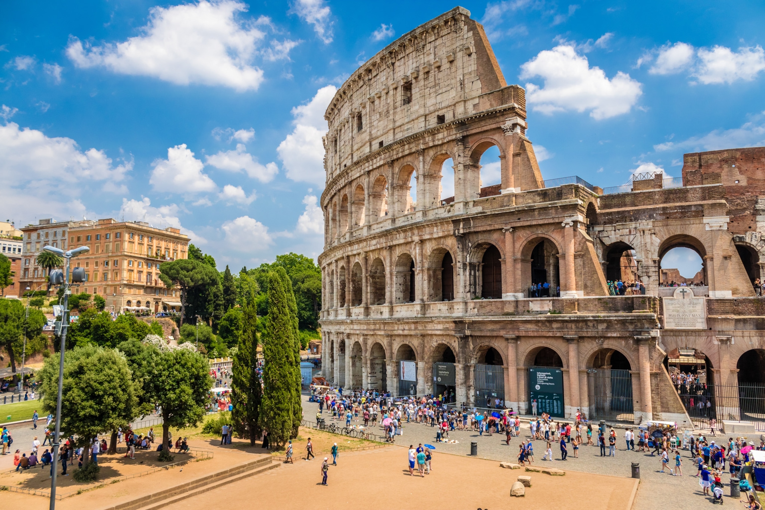the Colosseum and tourists on a sunny day in Rome, Italy
