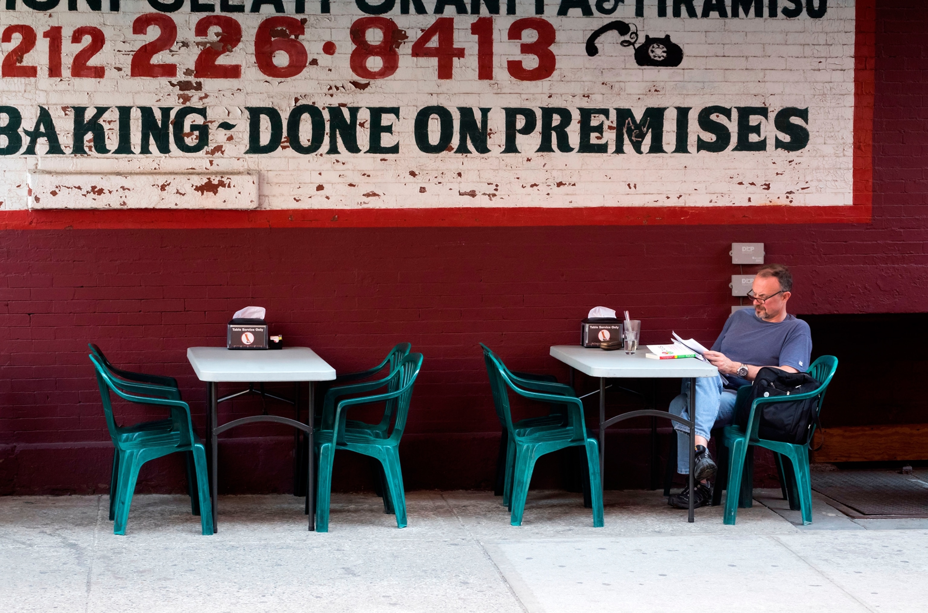 a man at a cafe dining in Little Italy, New York City, New York