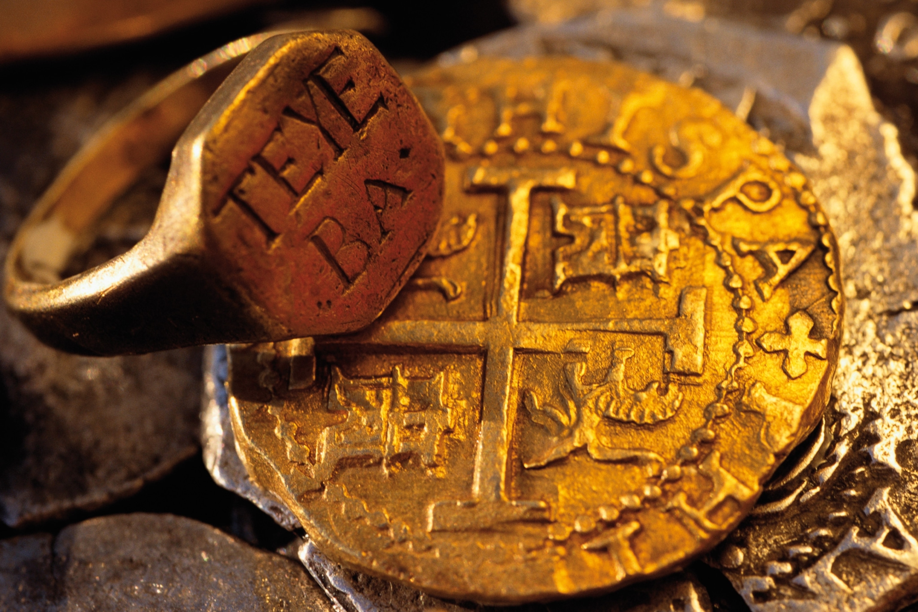 a gold doubloon and ring from the 1717 shipwreck of the pirate ship Whydah