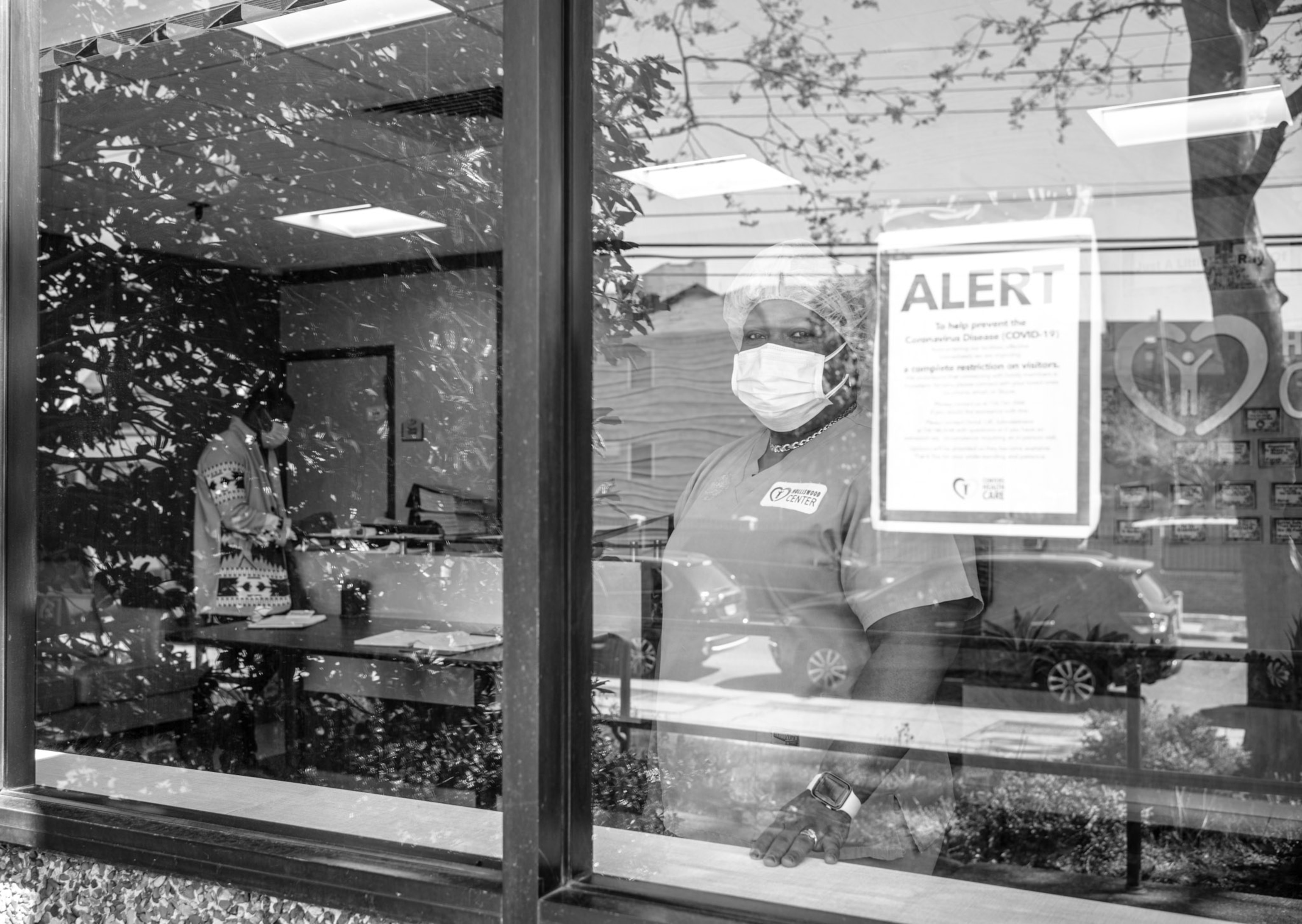 a person standing behind a window