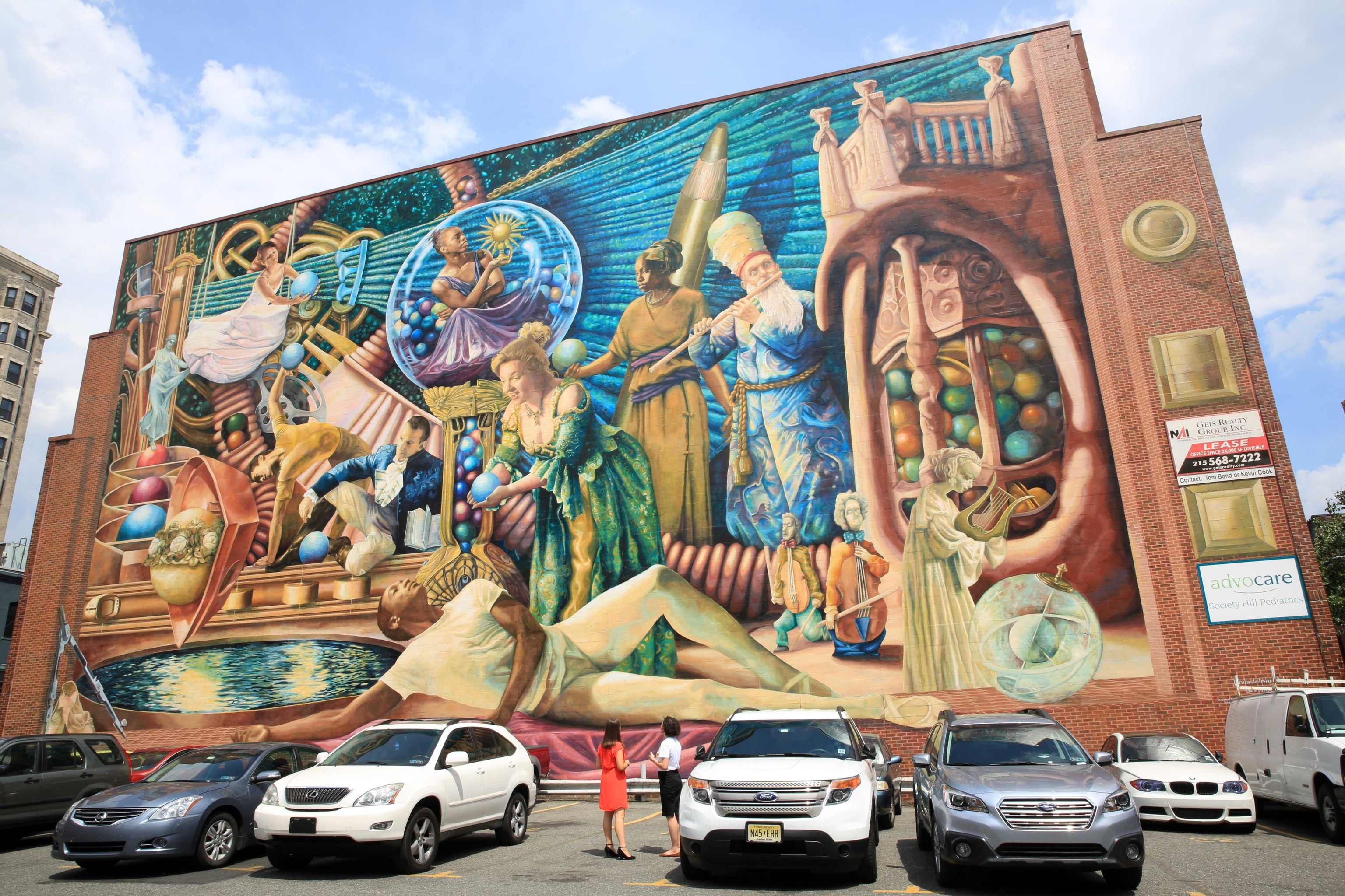 A large colourful mural on a brick wall