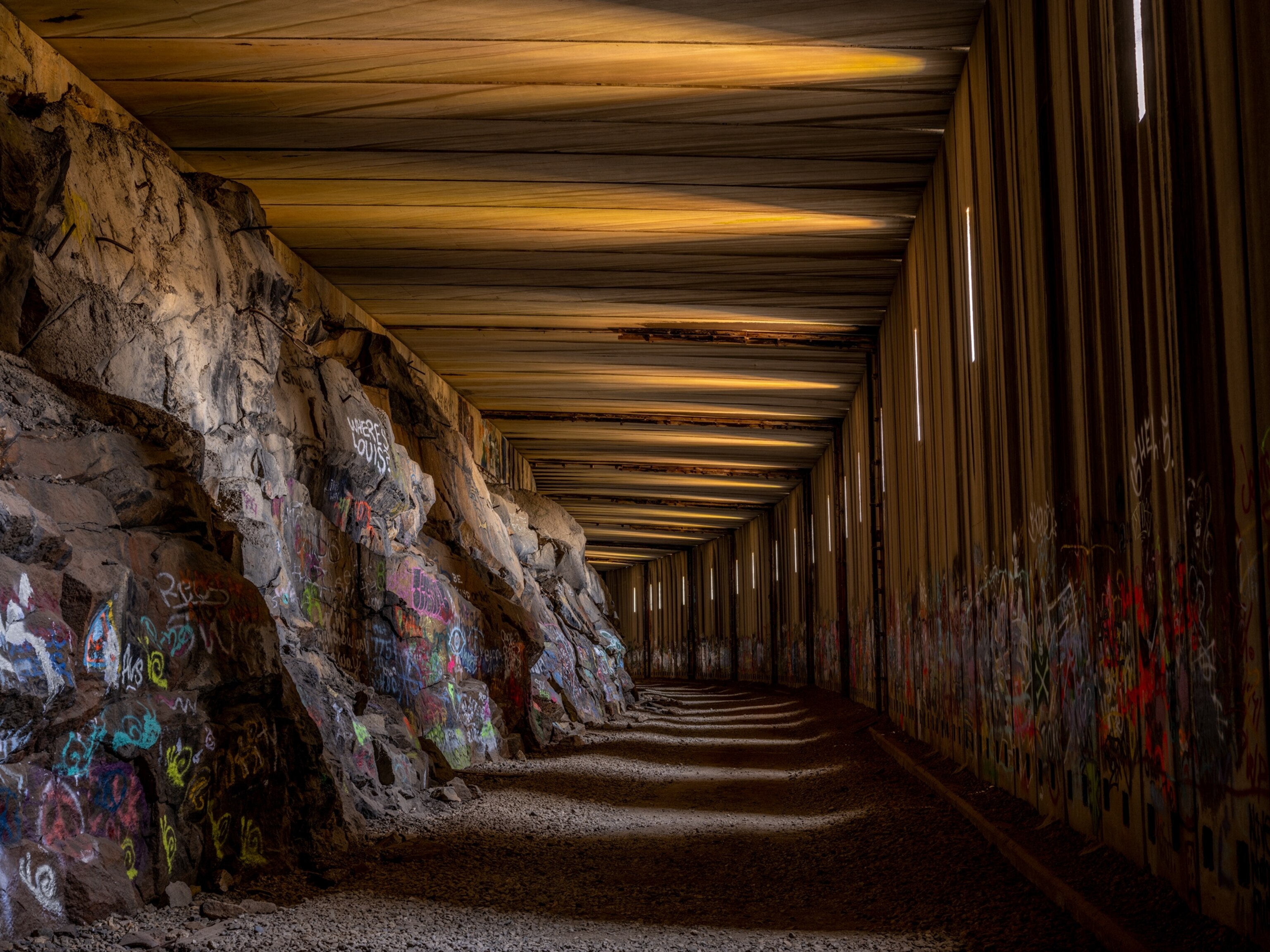 Tunnel with graffitis on the walls.