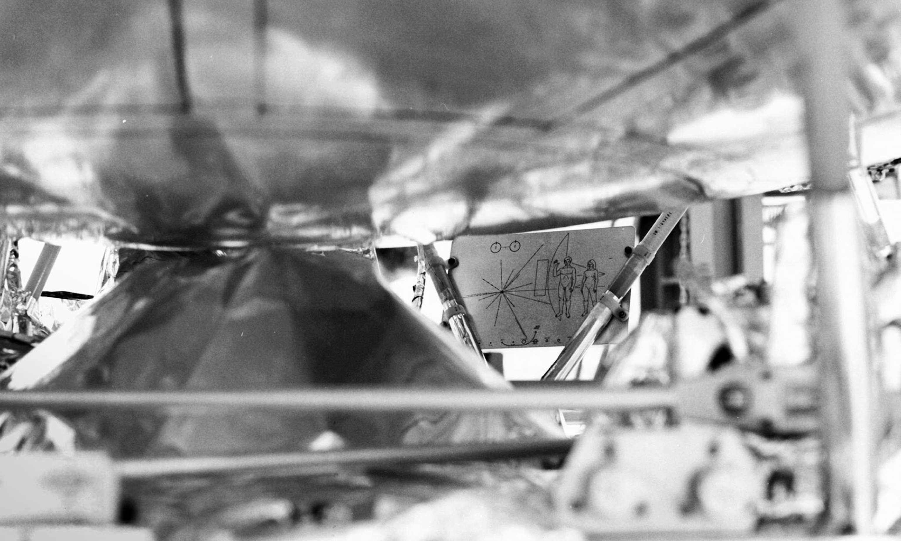 black&white photo of metal structure with map attached to it.