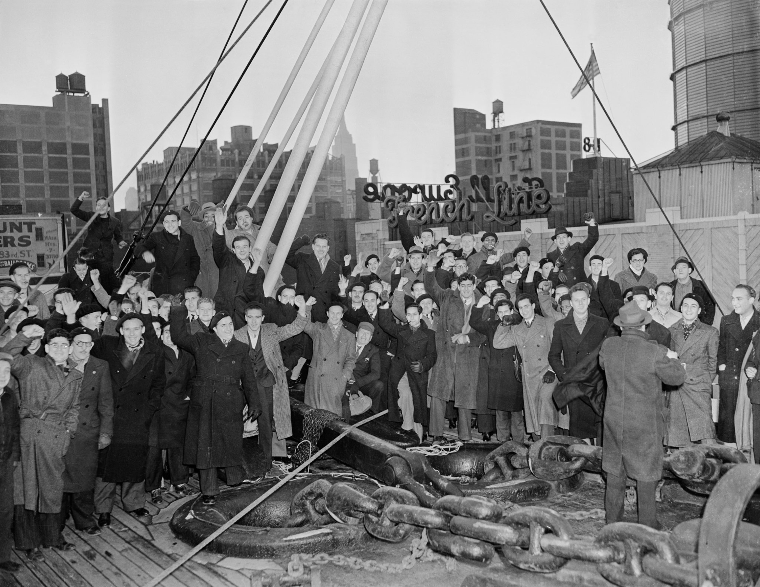 a crowd of white men on a boat raising their fist