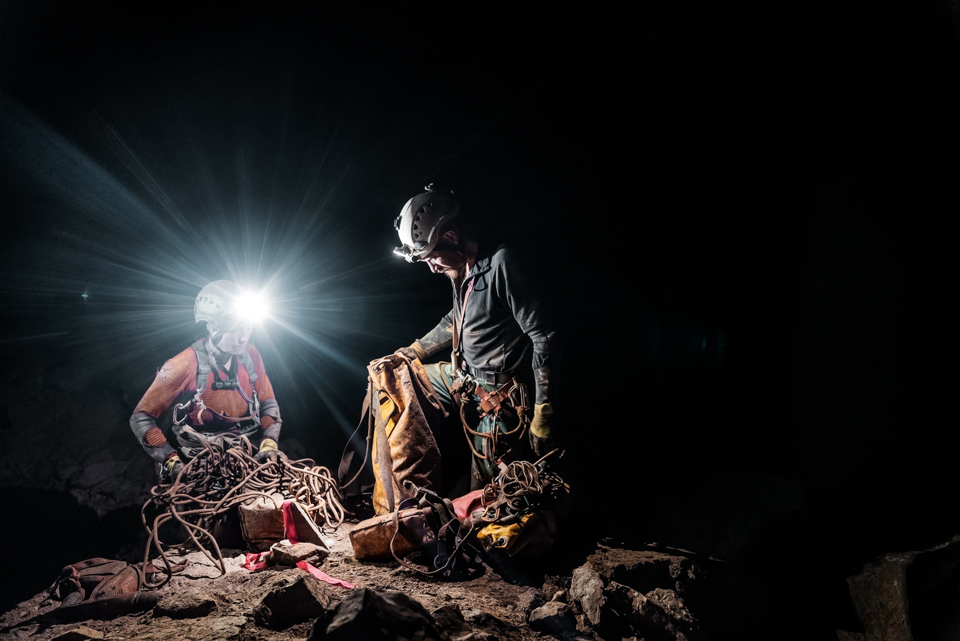 Picture of two persons sorting out the muddy equipment