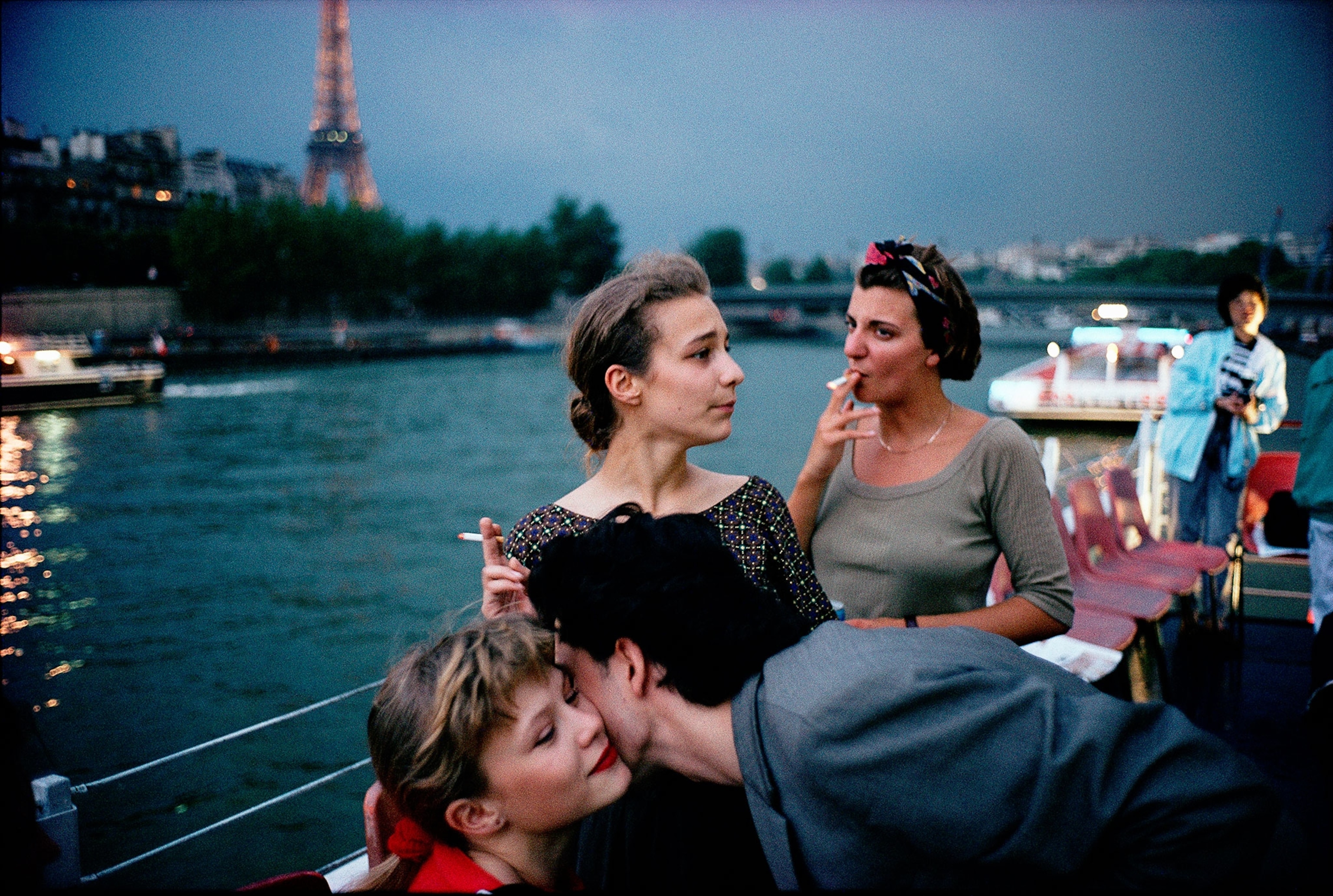 Friends celebrate the end of school on a twilight Seine River cruise