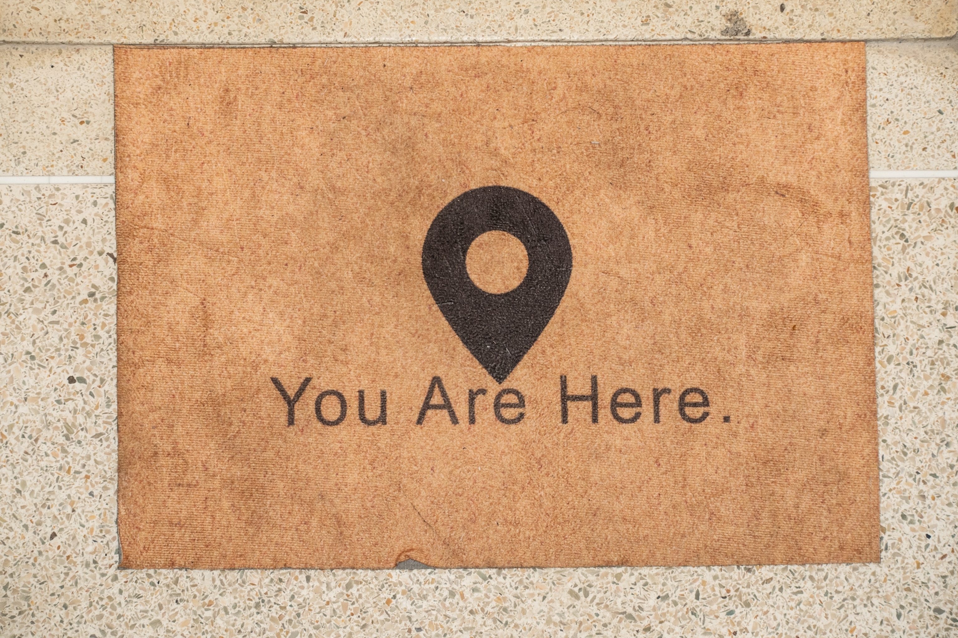 home entrance mat that says "you are here"