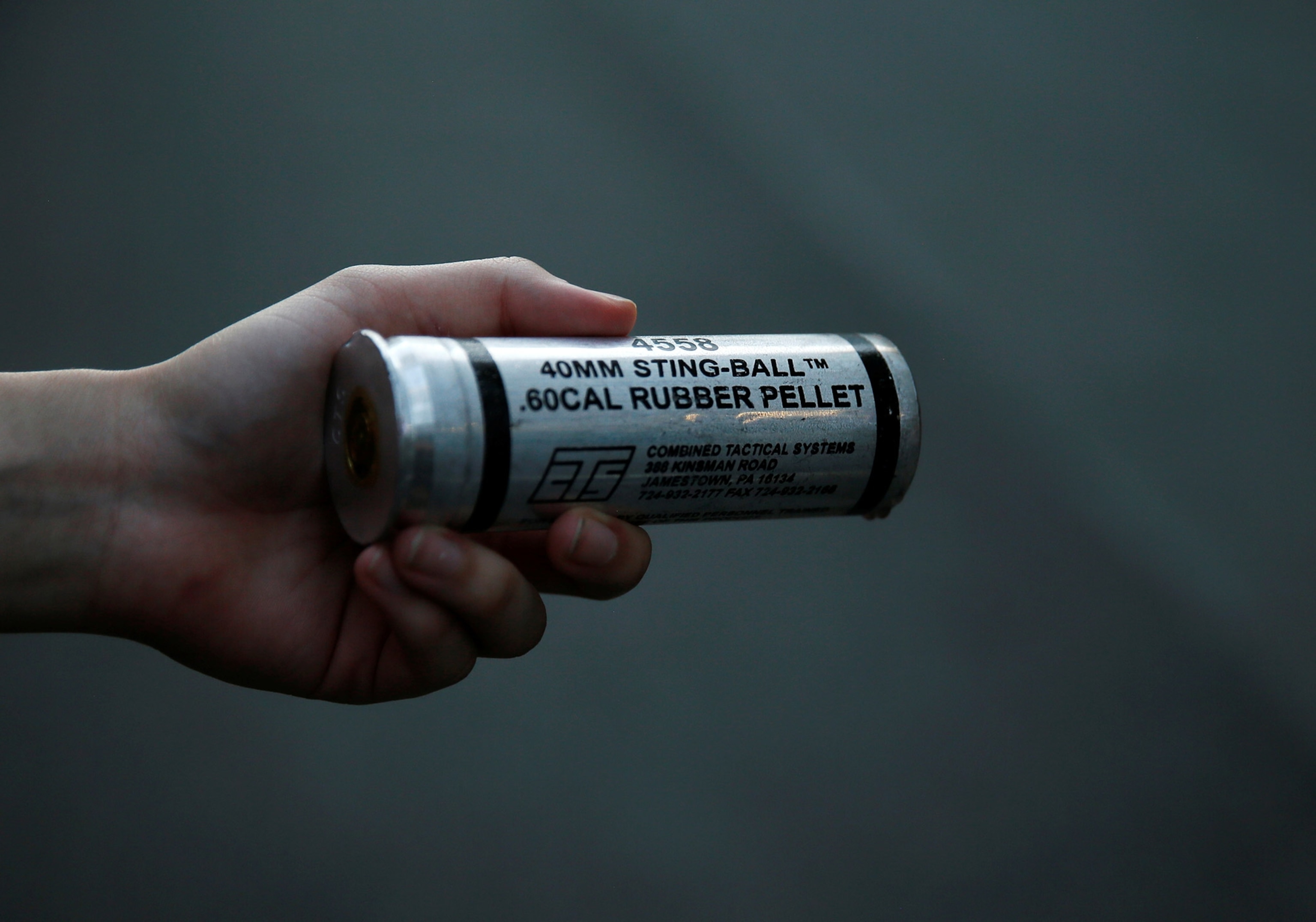 a demonstrator holding a rubber bullet in Washington