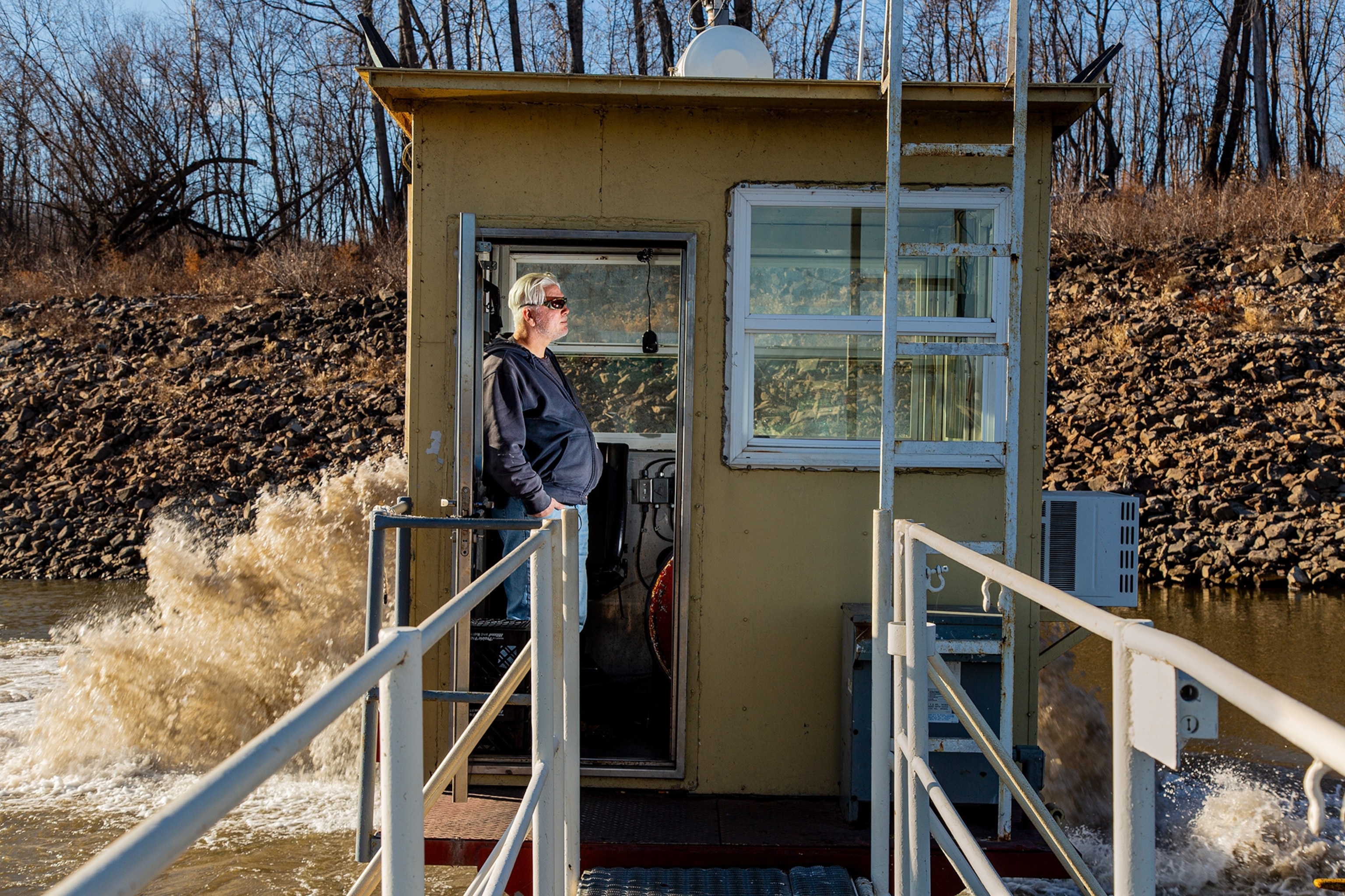 Portrait of man in the small control house on the Mississippi River.