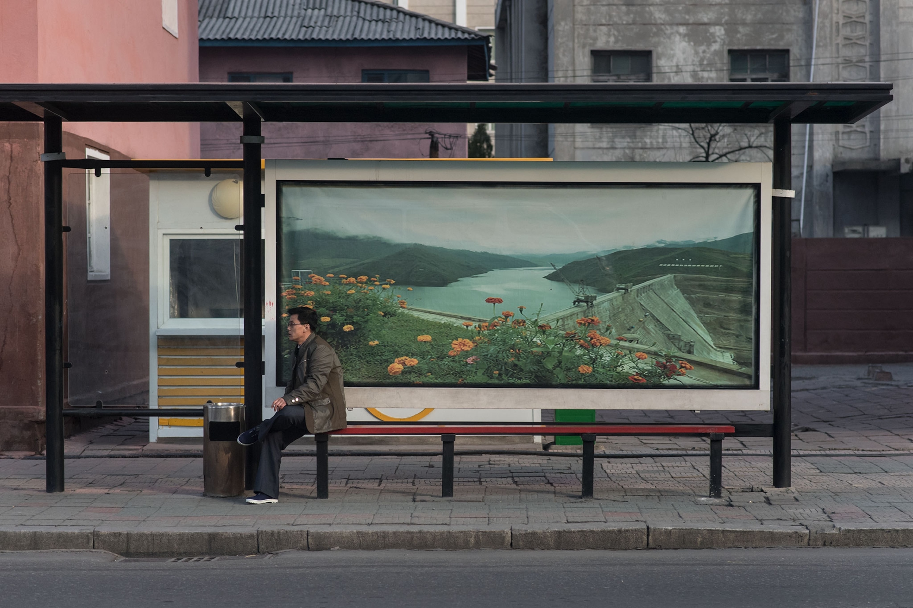 people waiting at a bus stop in North Korea