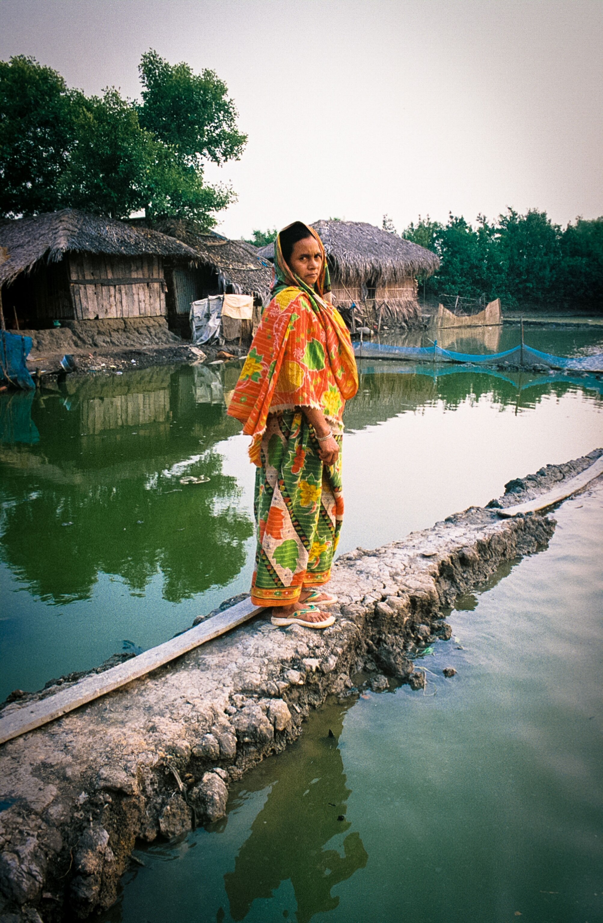 a woman walking by flooded water