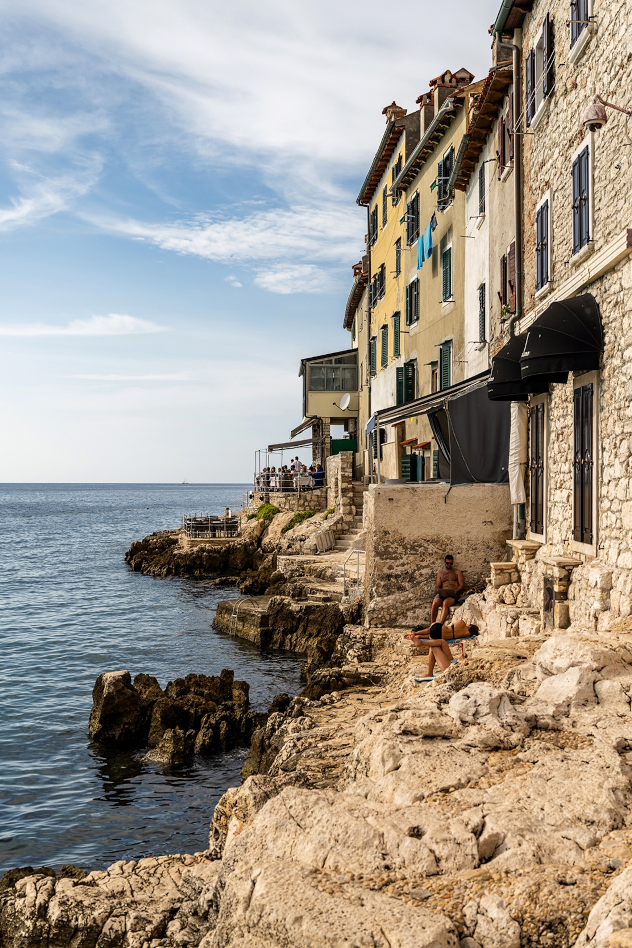 The shore of Rovinj's old town - filled with restaurants and bars, yet still offering a place to swim and soak up the sun