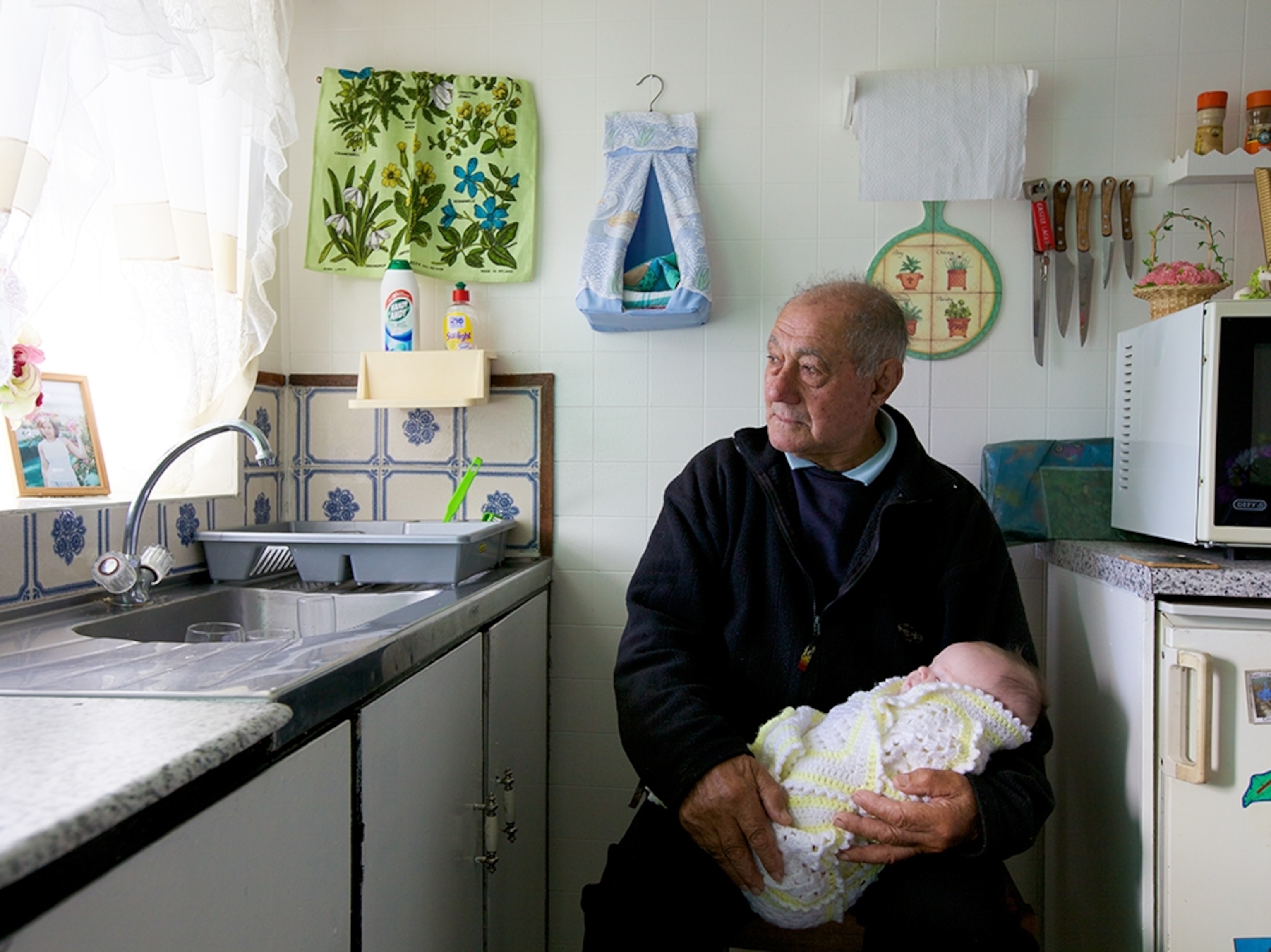 man holding his great-grandchild