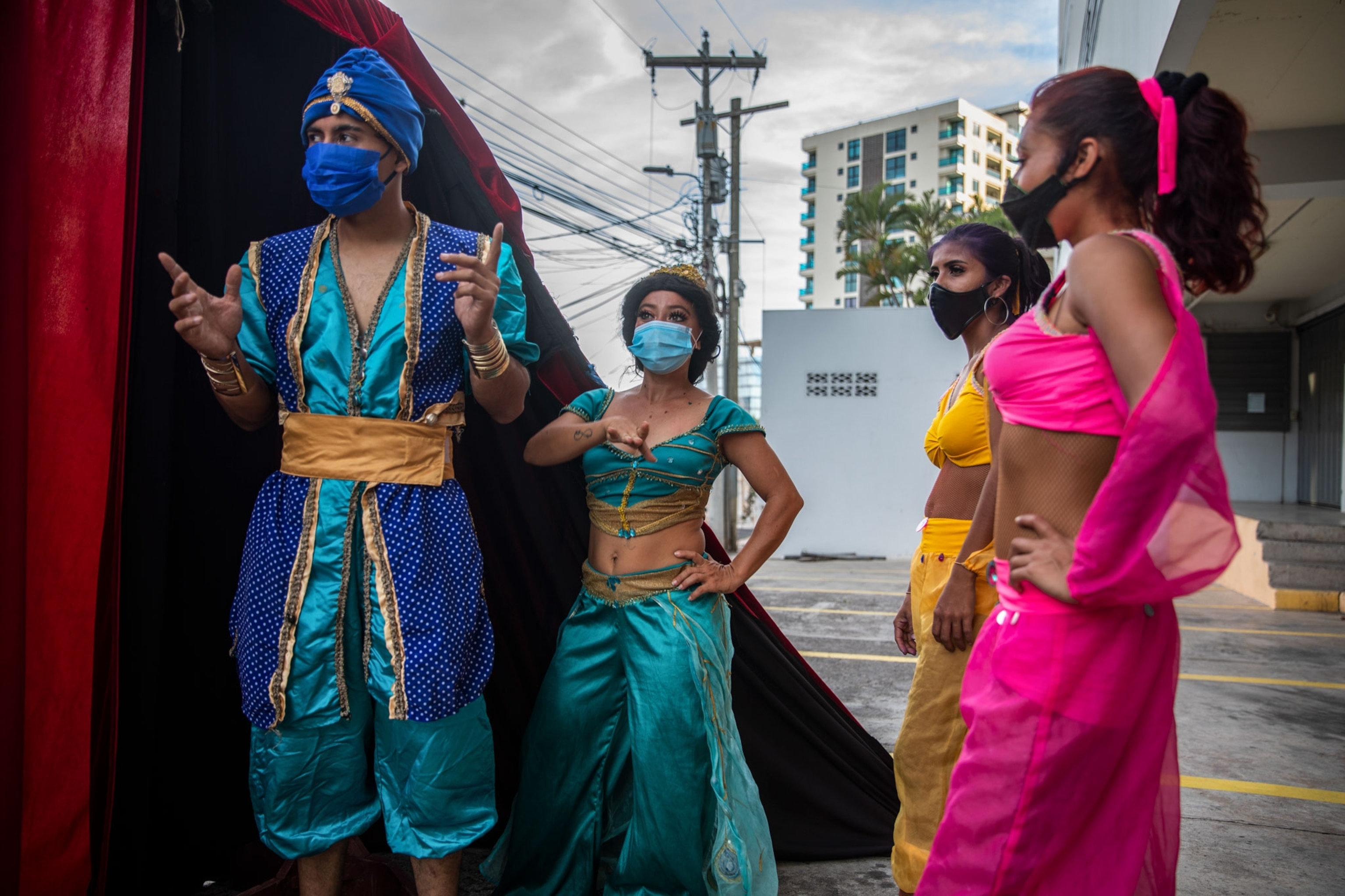 a circus performers performing on the street in a wealthy neighborhood in Honduras