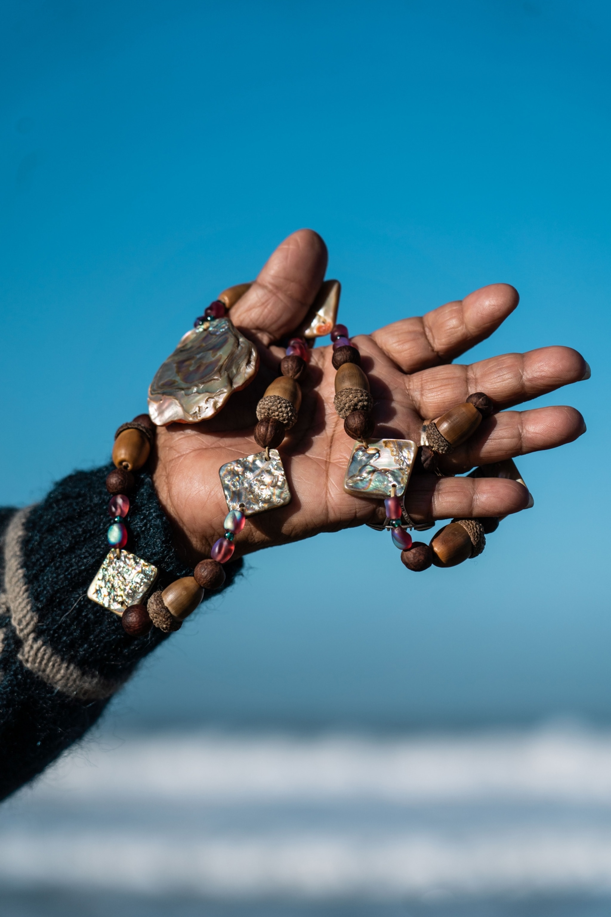 A necklace made from abalone shell fragments, manzanita berries, and acorns