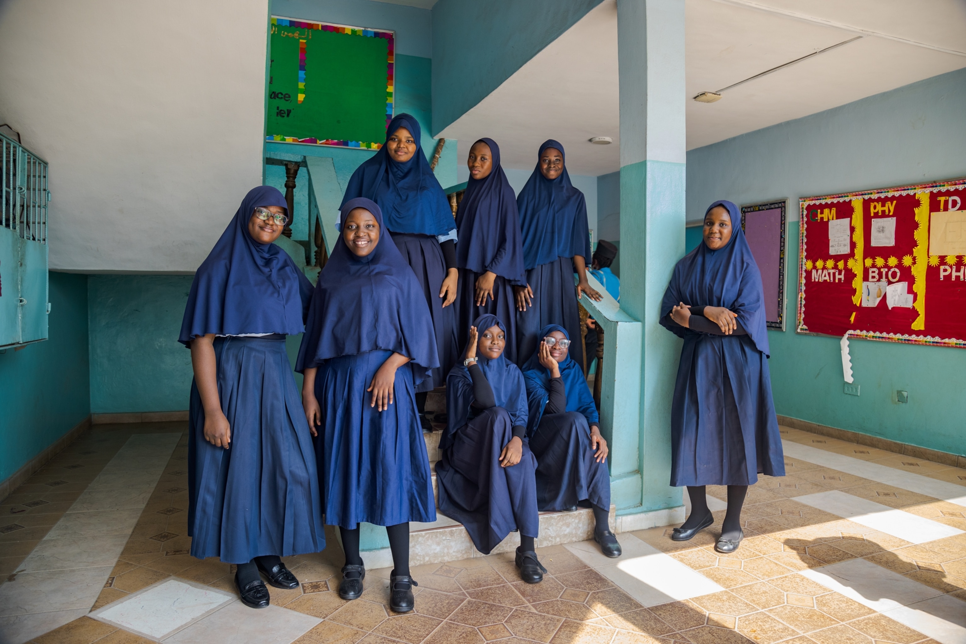 Picture of group portrait of girls dressed in blue with heads covered in blue scarfs.