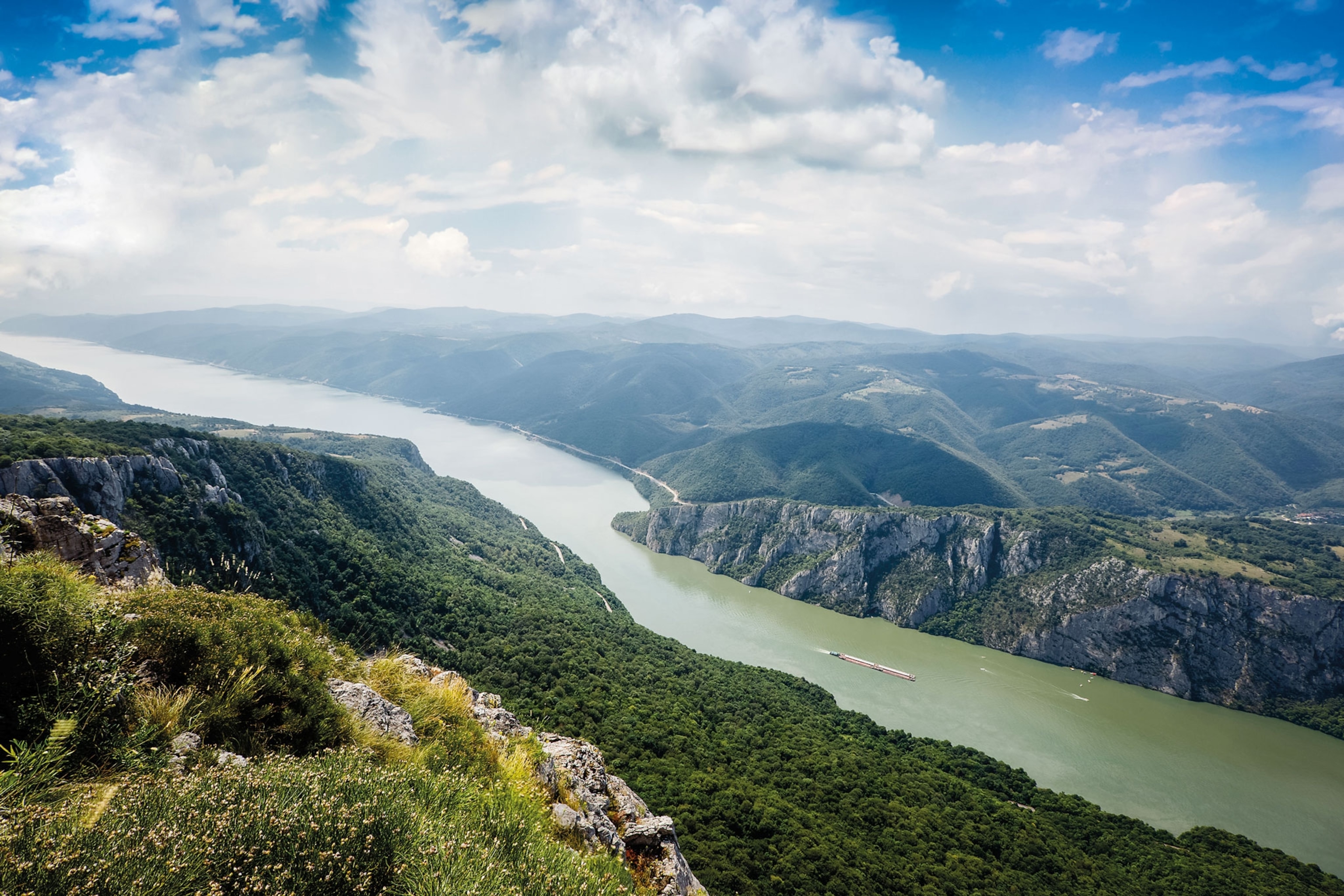 a wide river cutting through a vast landscape