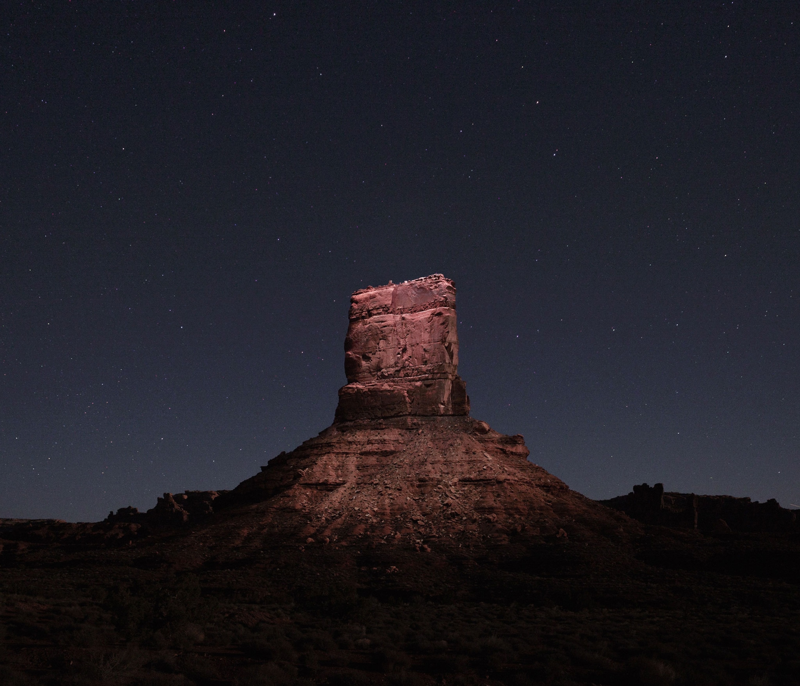 a rock formation lit at night