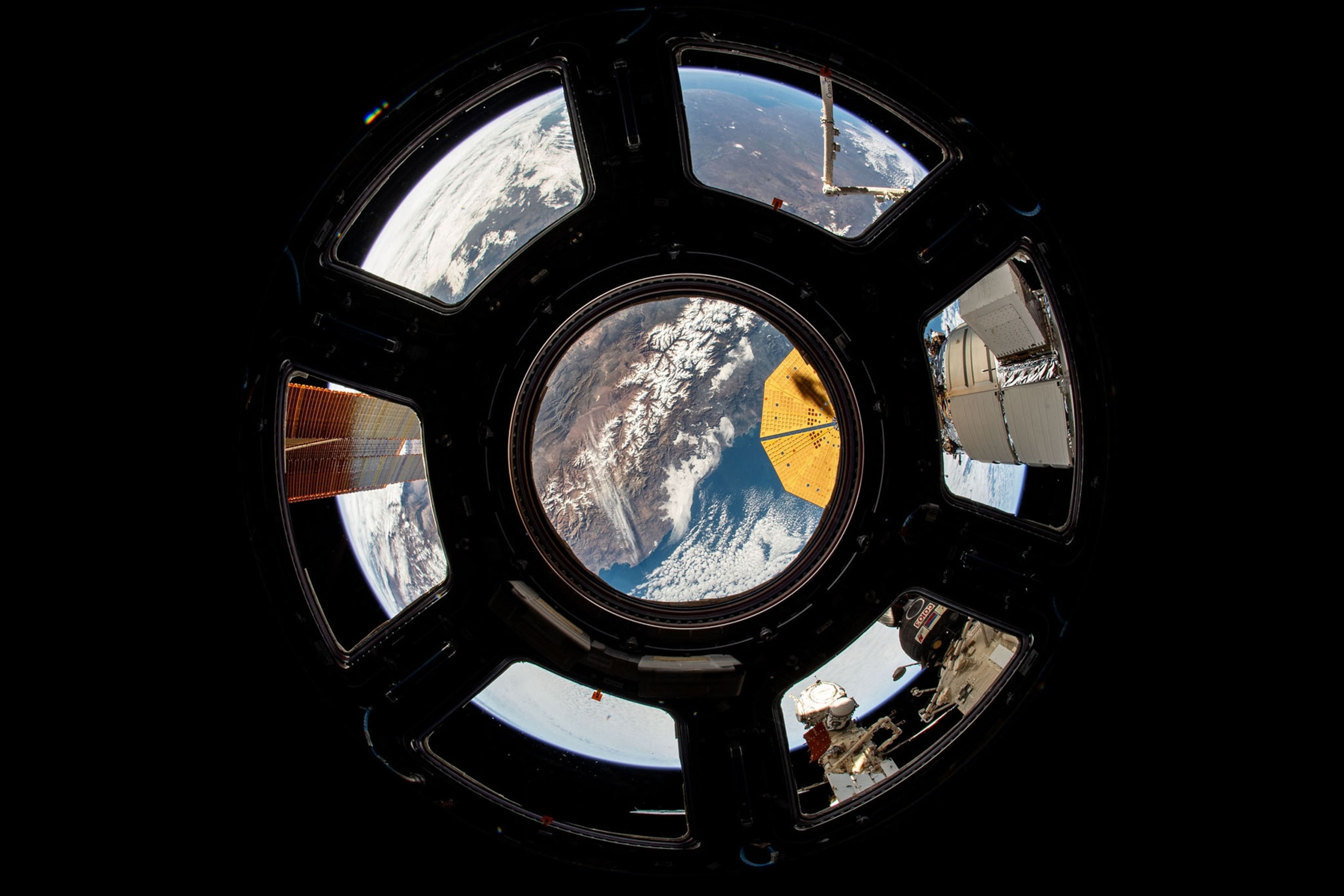 A round window looking over colorful Ears surface.