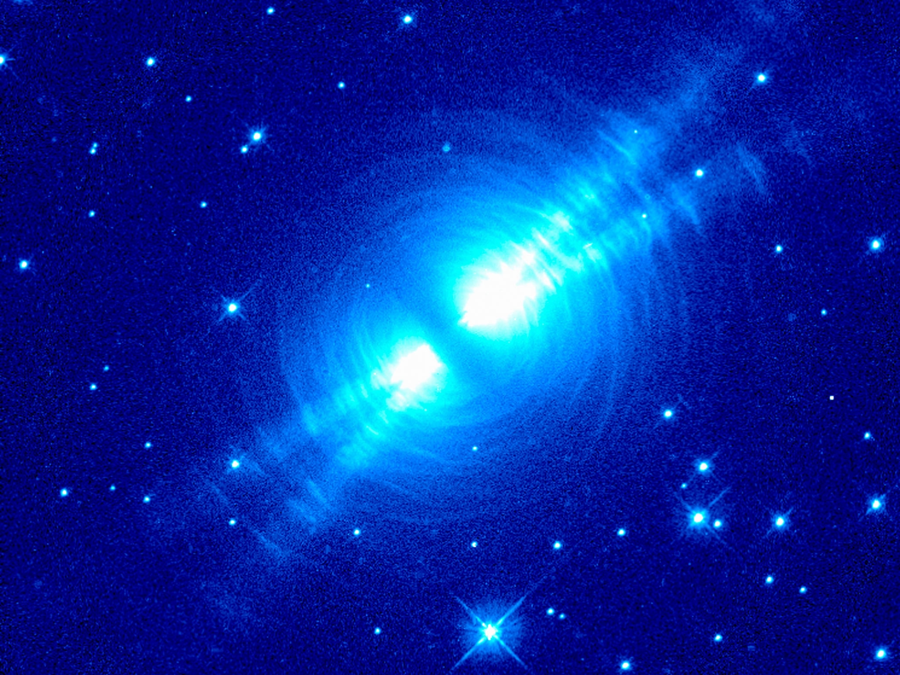 Neon-blue cross of light on cobalt-blue skies with bright stars.