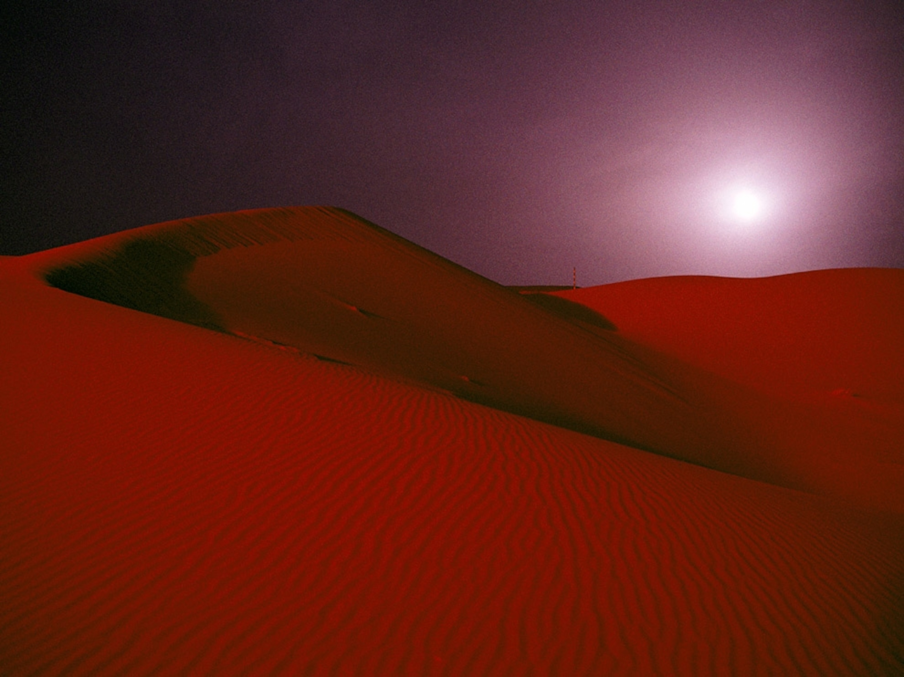 Moon over sand dunes