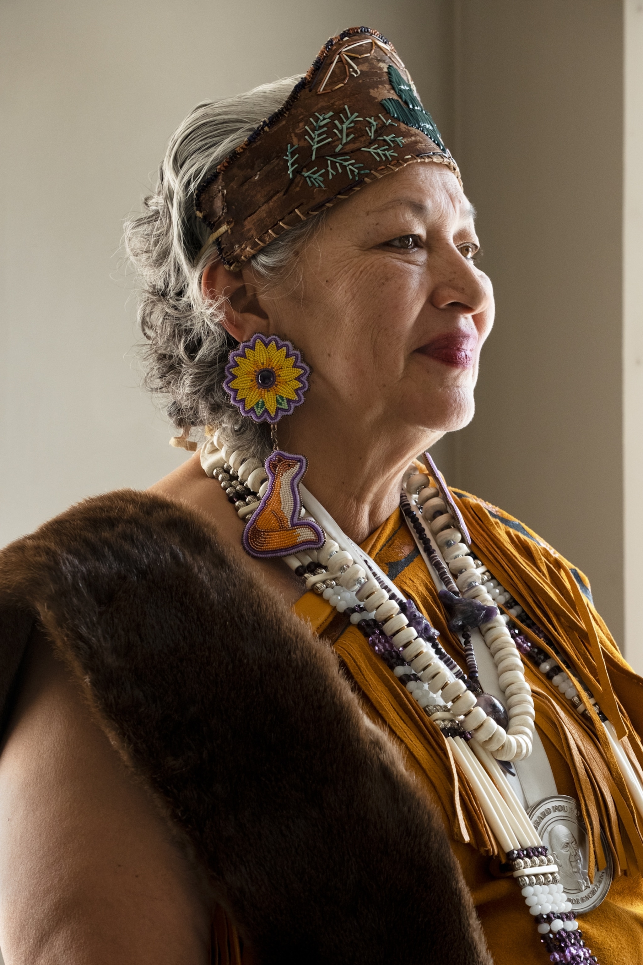 Portrait of a woman in tiara and earings in shape of sunflower and fox.