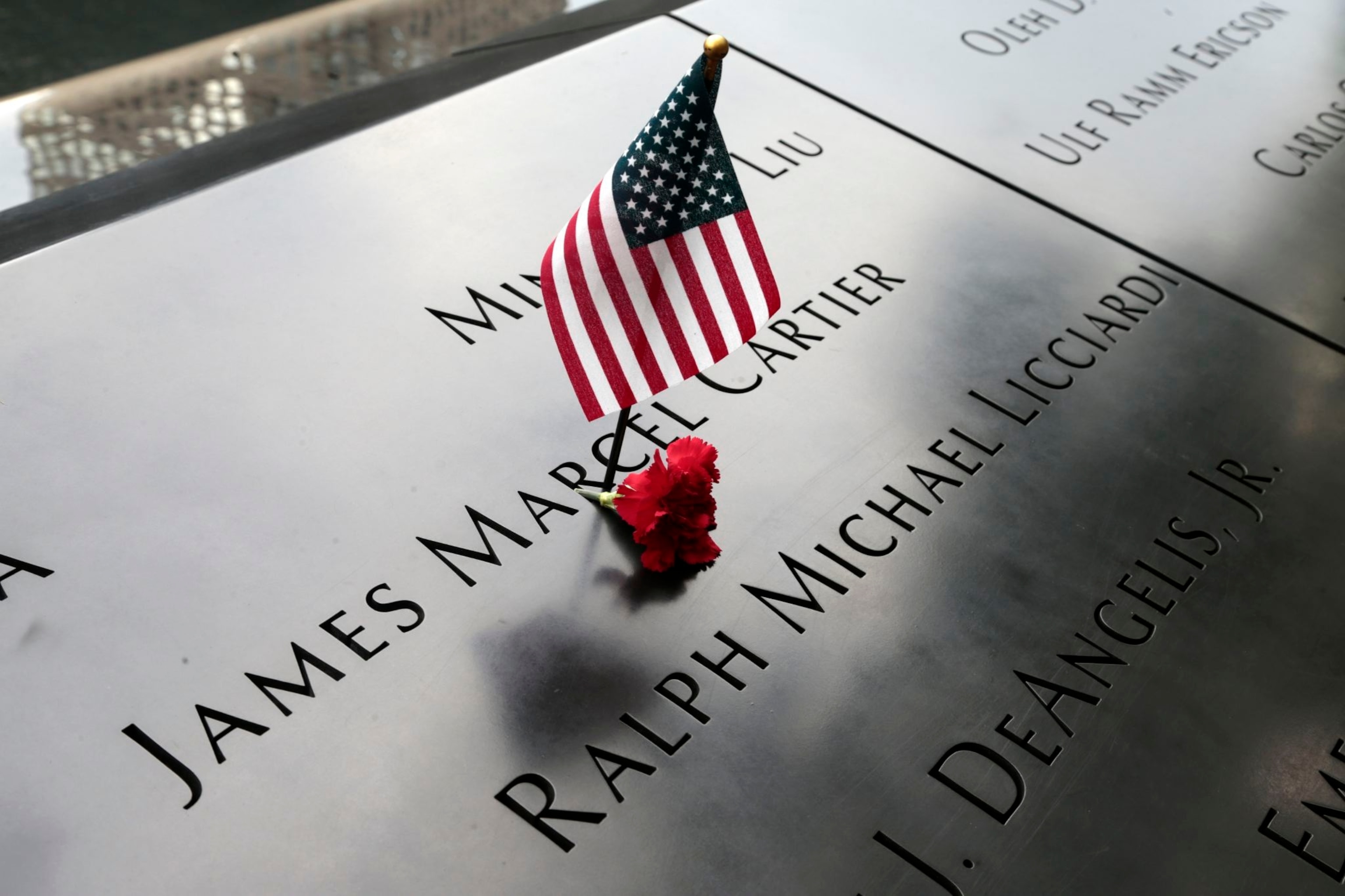 flowers left behind on the 9/11 memorial in honor of the victims of the World Trade Center attack