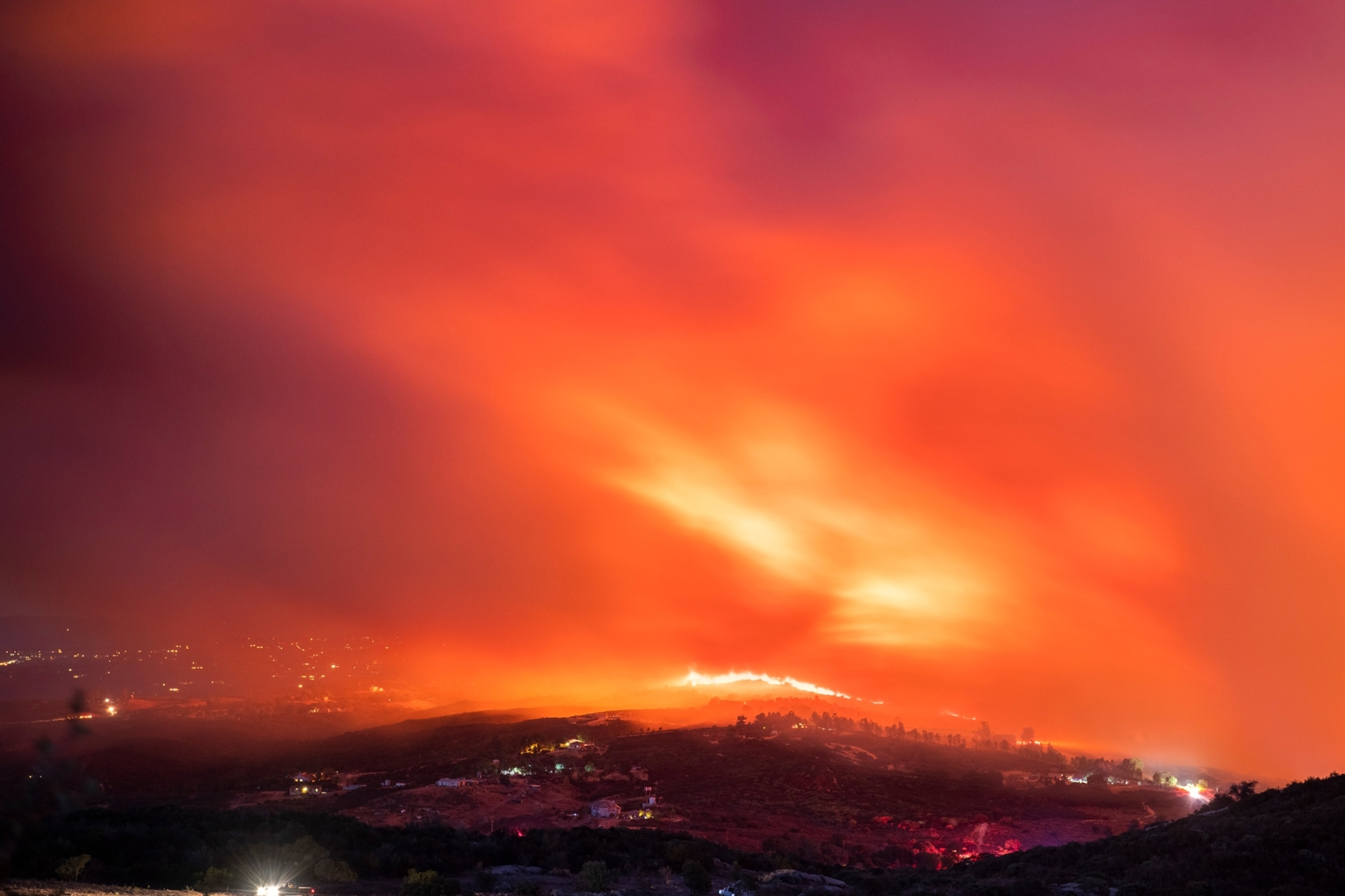 the smokey skyline of fires burning in the distance