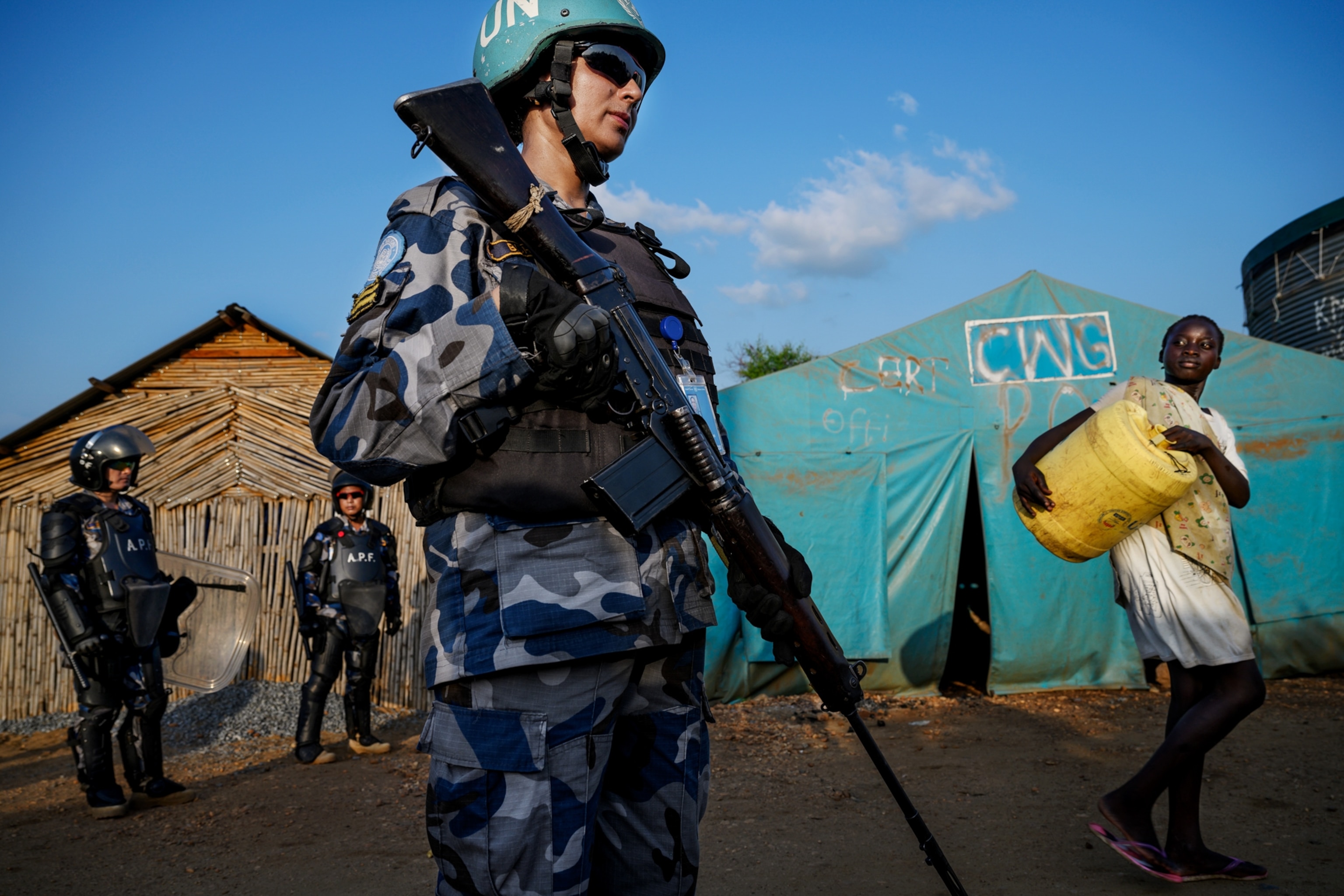 a woman soldier standing outside of a tent