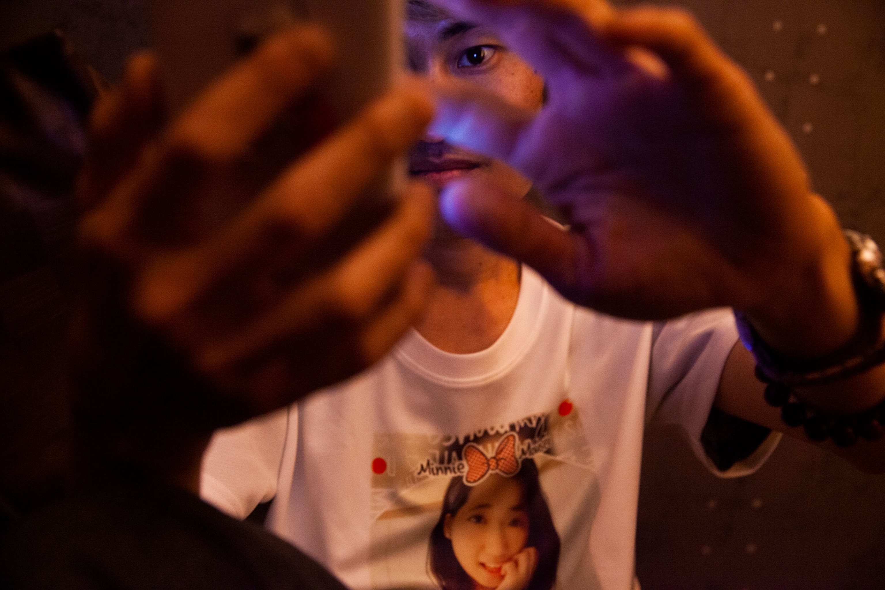 a man watching a livestreamer in an internet cafe in Taiwan