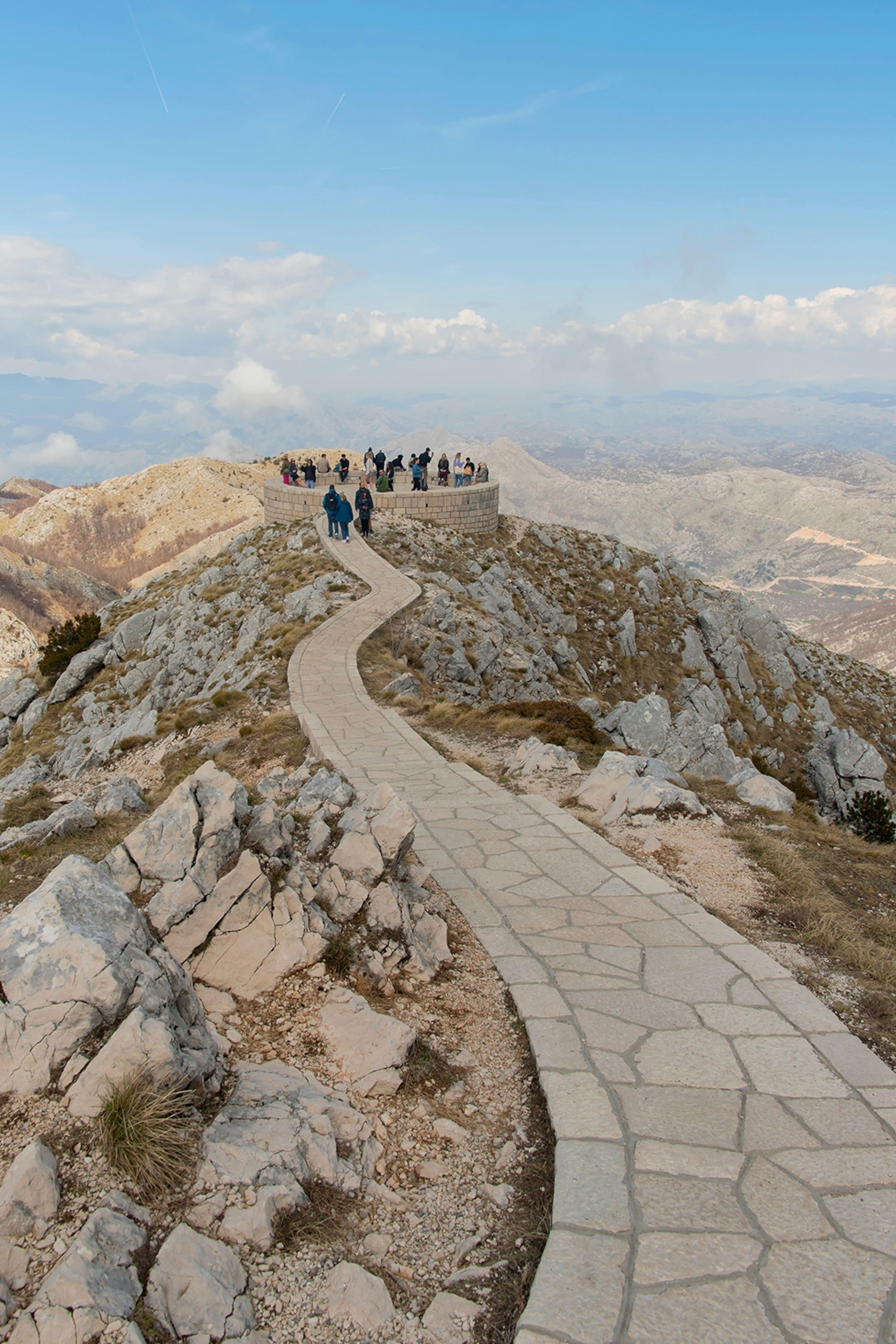 Tourists at the viewpoint of a rocky mountain summit