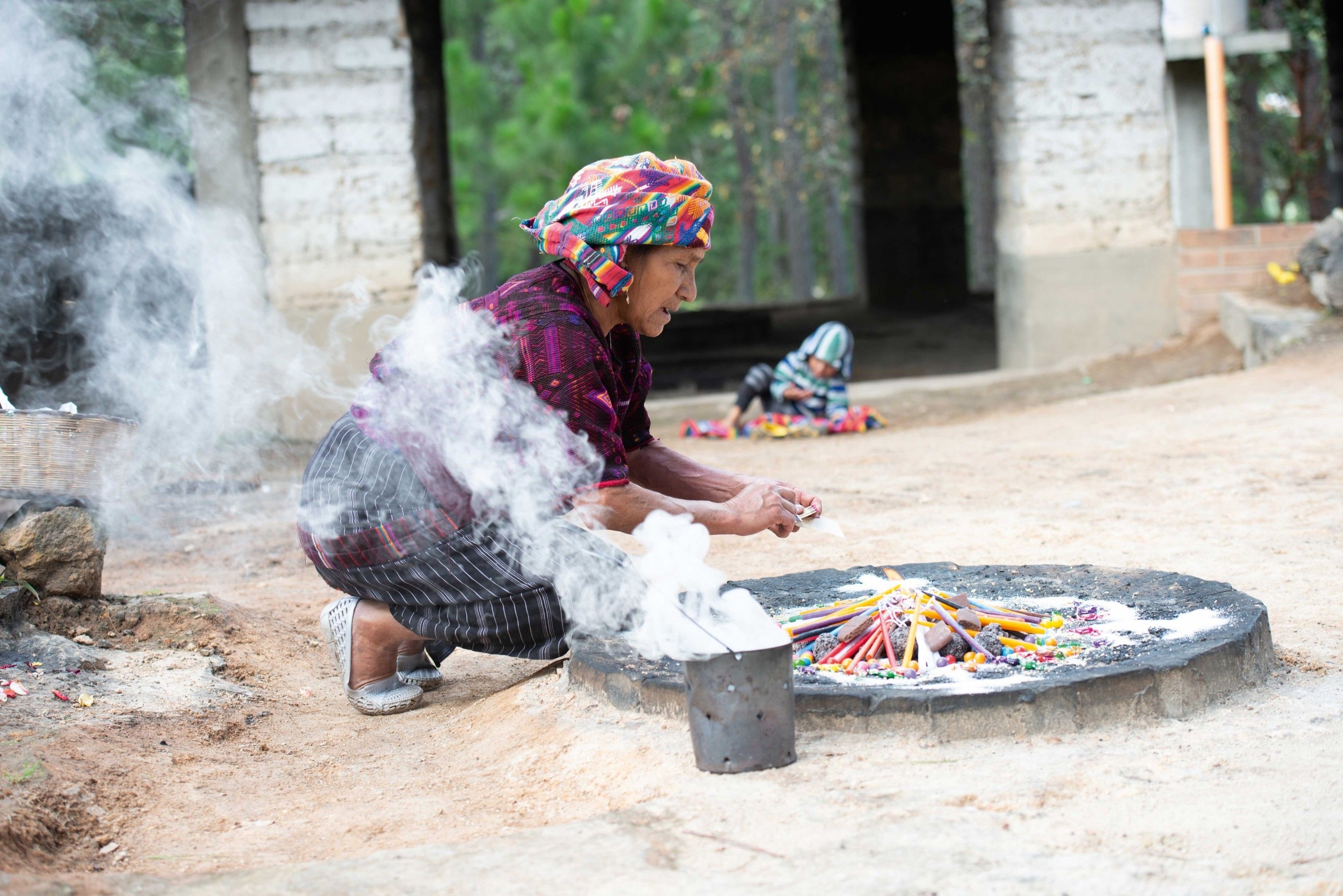 Juanita, shaman Diego Ignacio’s wife, lights a blessing bonfire atop the sacred hill of Pascual Abaj, Chichicastenango.