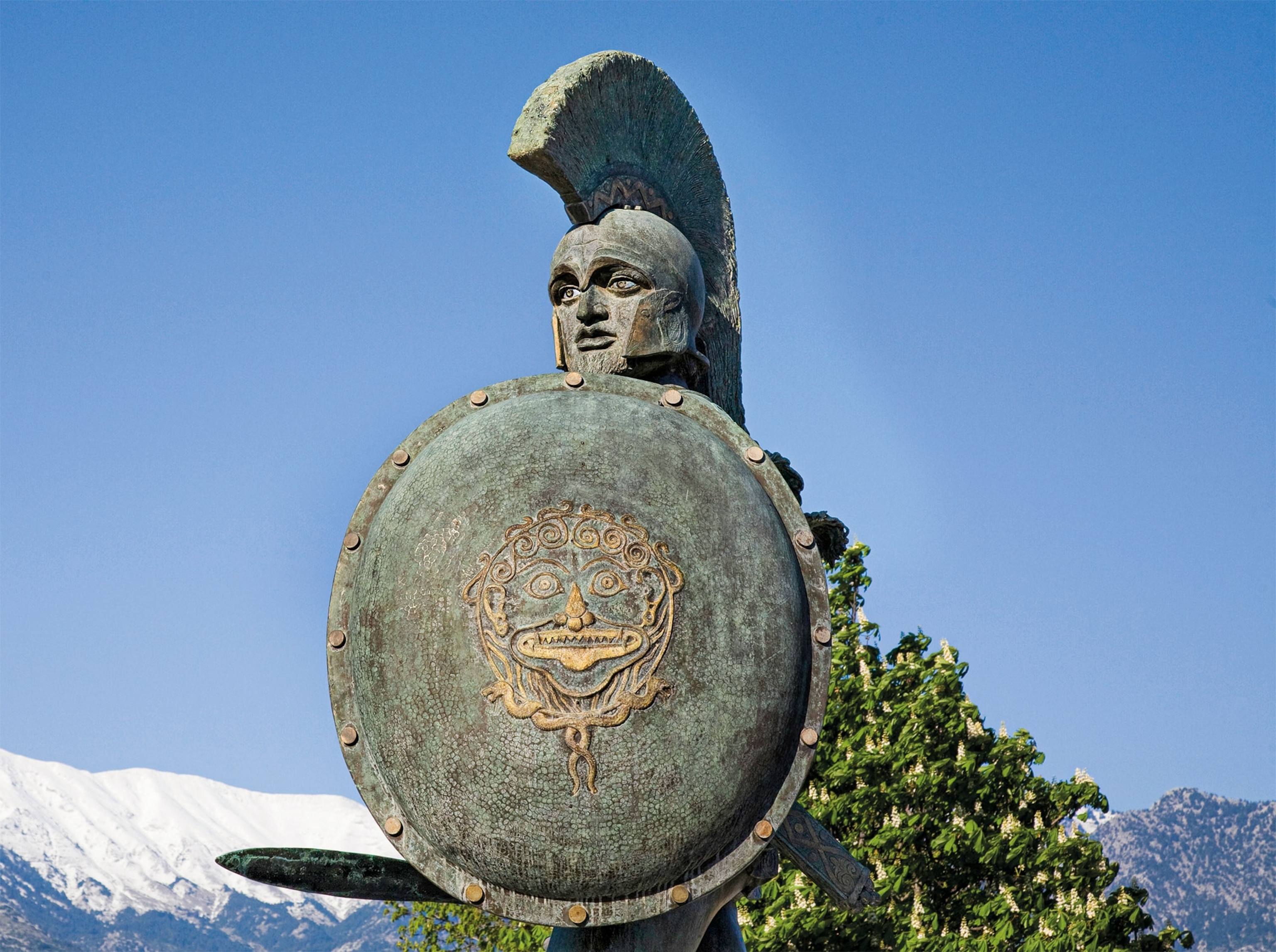 A bronze statue of Kinng Leonidas wearing armor holding a shield