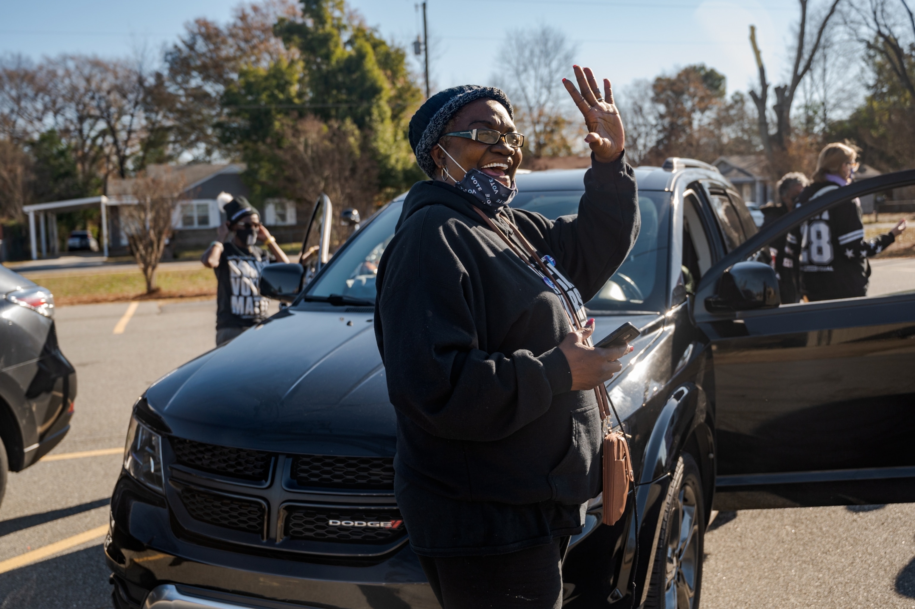 A woman waves.