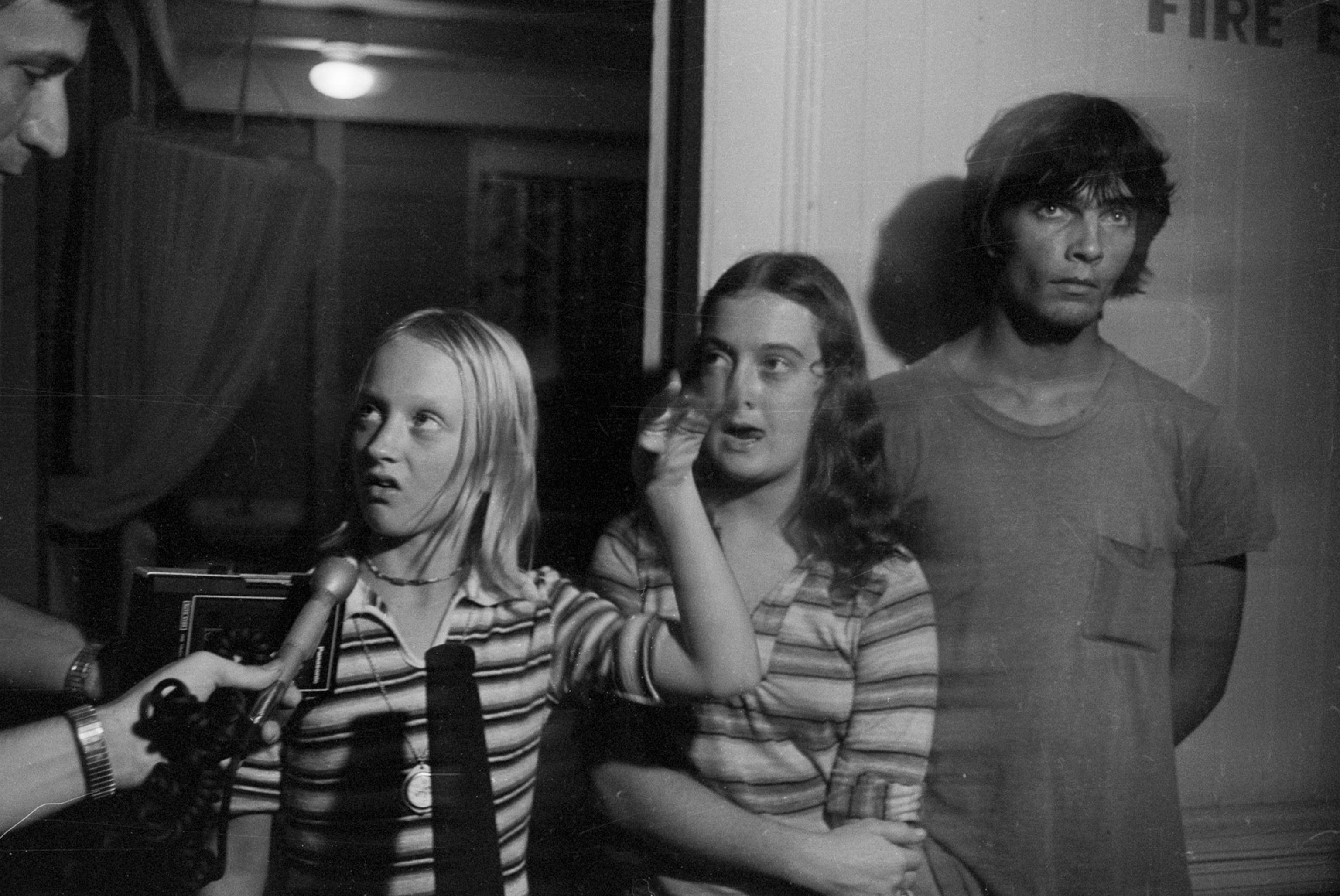 Three kids talking to a reporter.