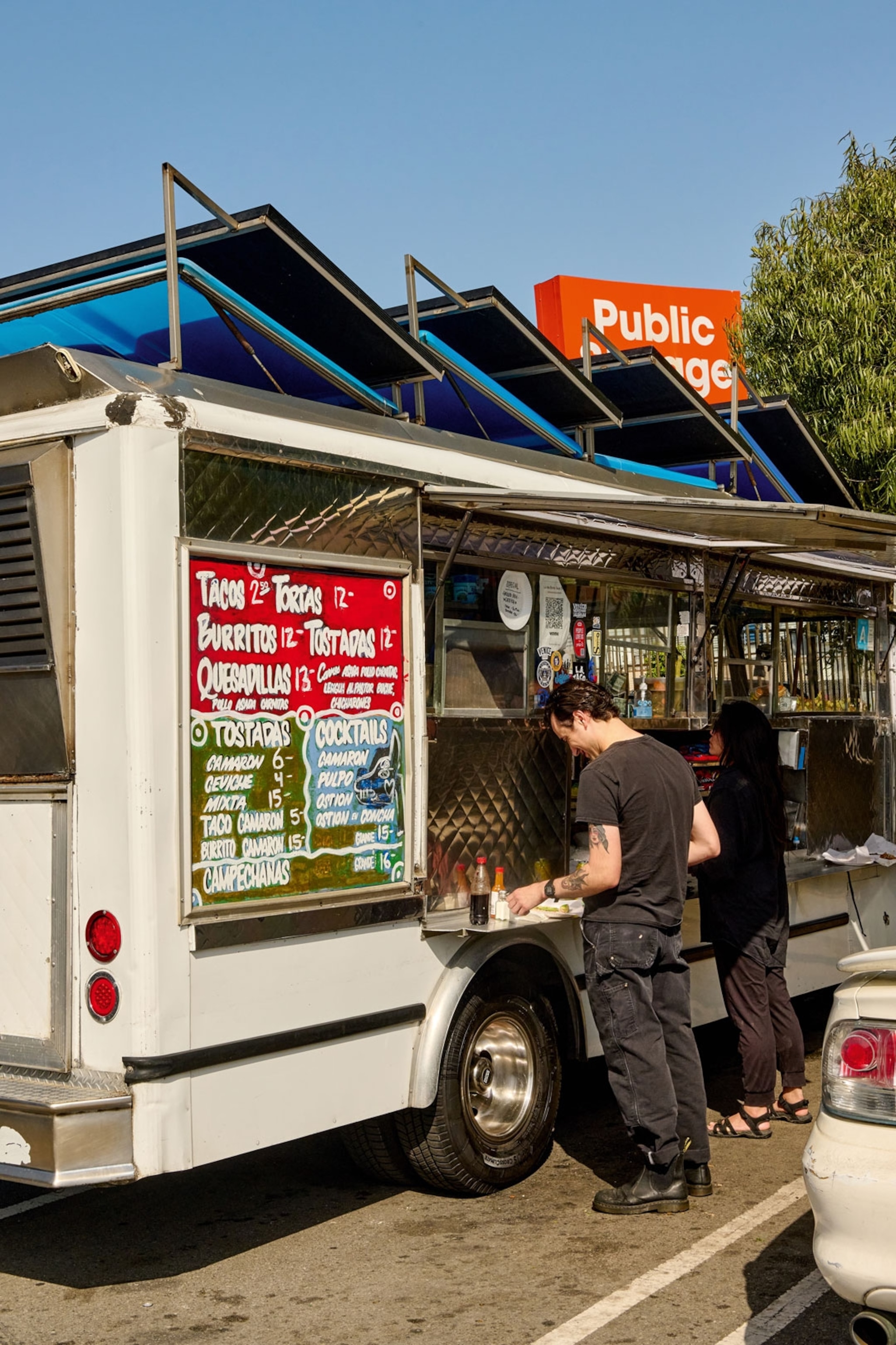 Customers stand at a food truck