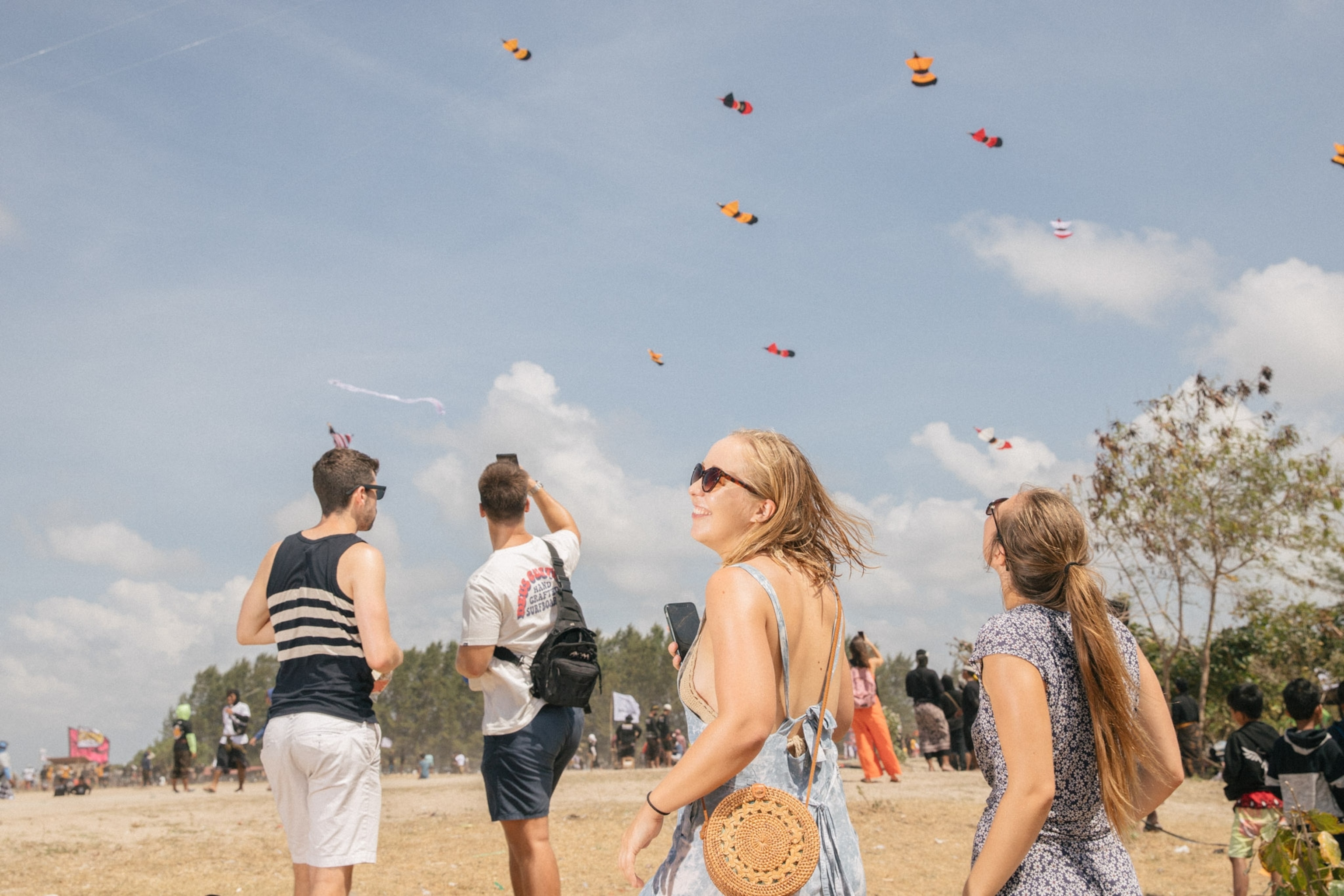 Tourists watch kites in the sky in Bali, Indonesia.