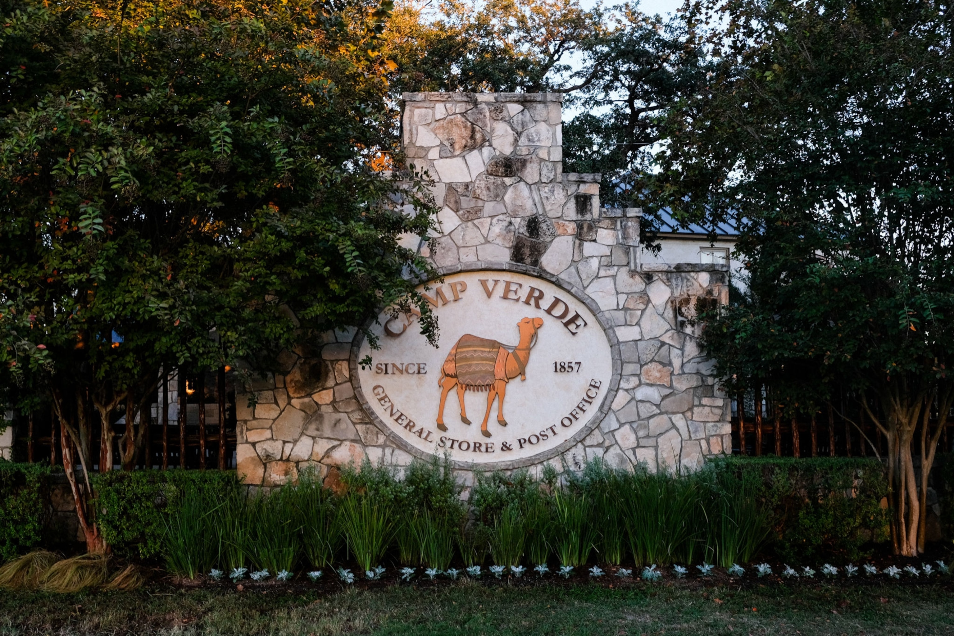 Signage featuring a camel alongside Historic Camp Verde’s General Store and Post office